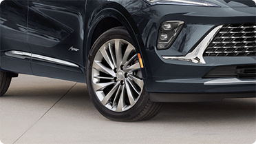 Close-up of a Buick SUV front wheel, tire, and grille, highlighting components covered by Buick Protection Plans and vehicle service protection.
