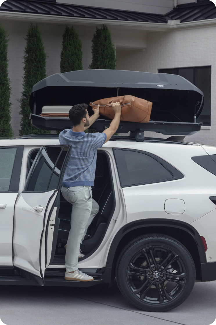 person packing luggage with car accessory
