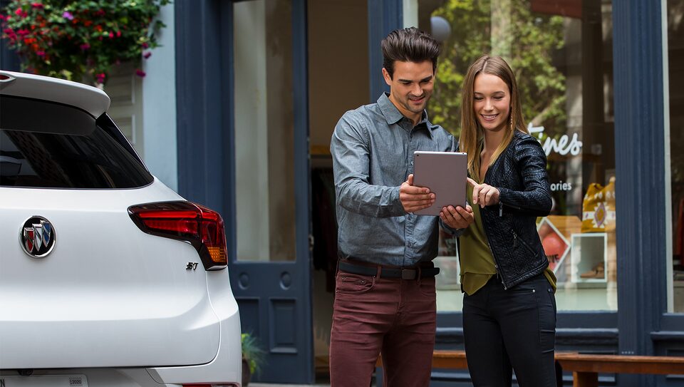 Couple Checking My Buick Rewards Statement on Tablet
