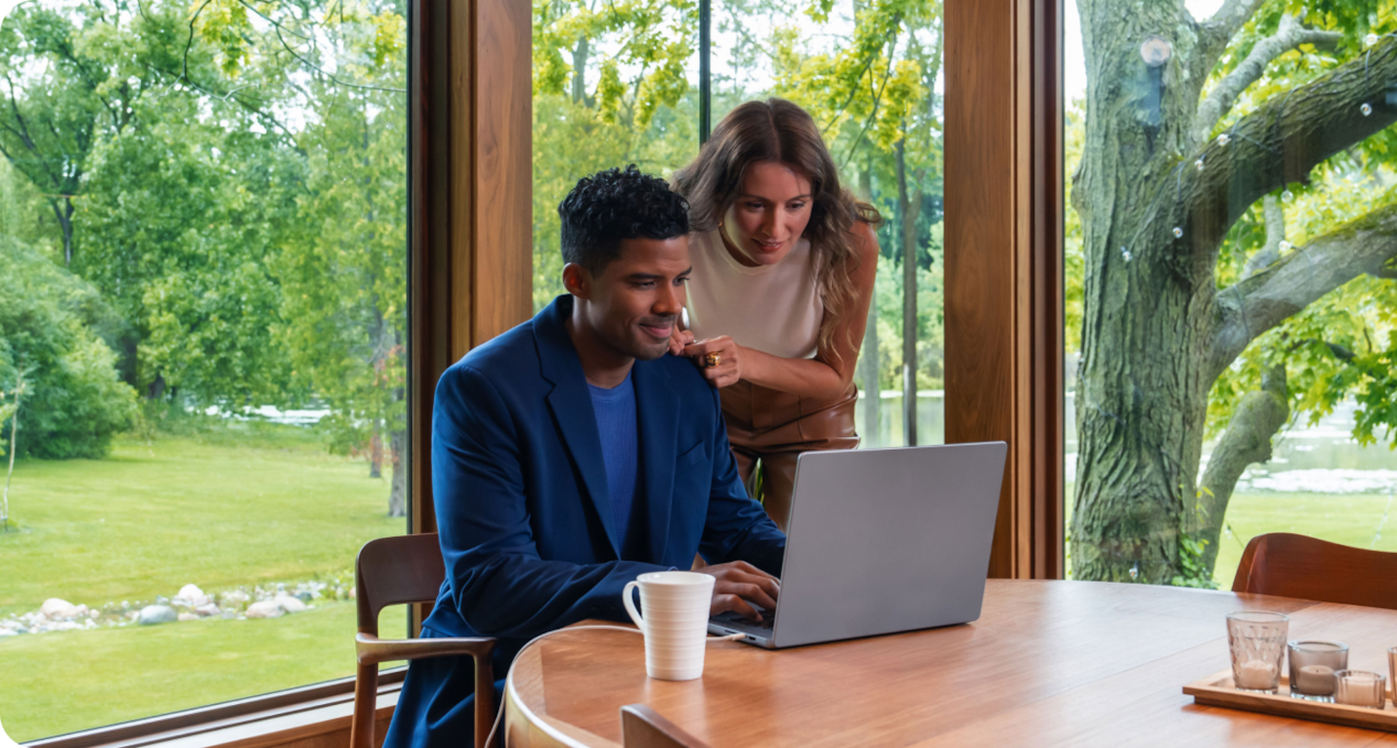 Two people viewing laptop