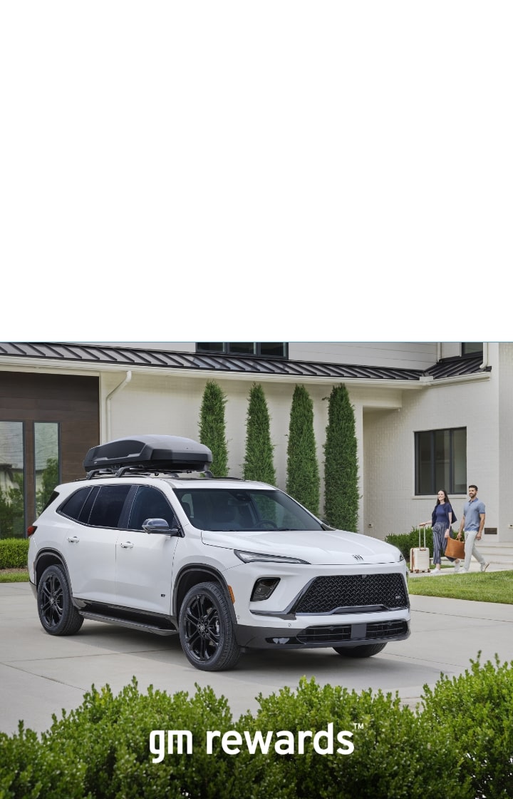 two people with luggage and white Buick