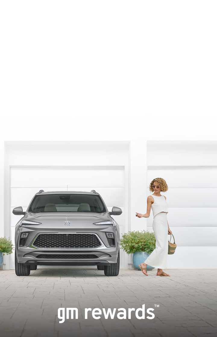 woman in white locking a Buick