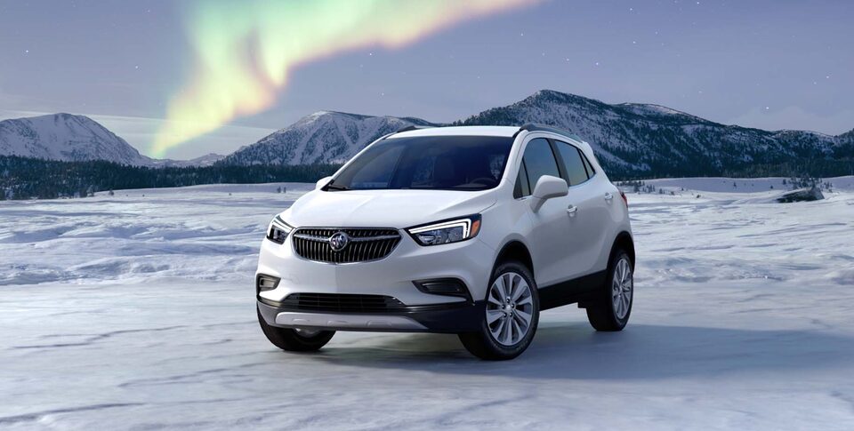 2021 Buick Encore: Small SUV Three-Quarter Front View Parked By Snow Covered Mountains