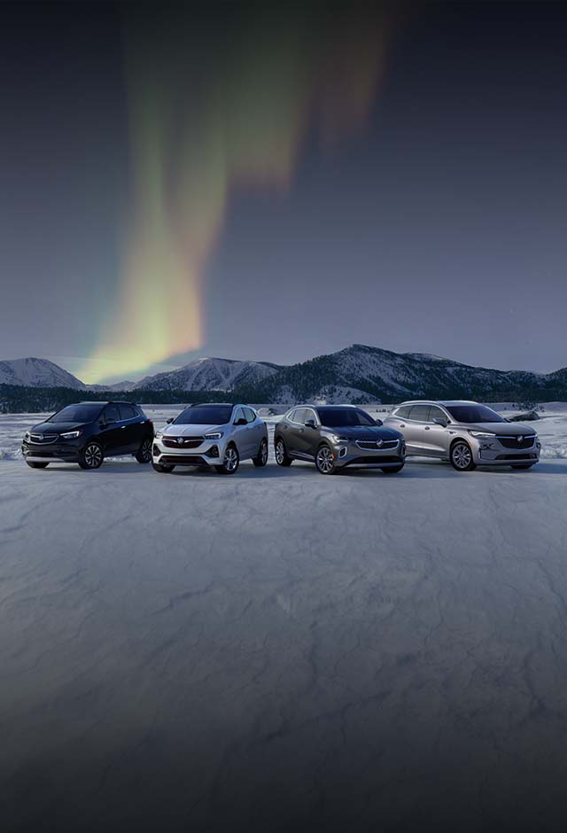 A Far Away Shot of the Buick Lineup of Vehicles Parked on Snow