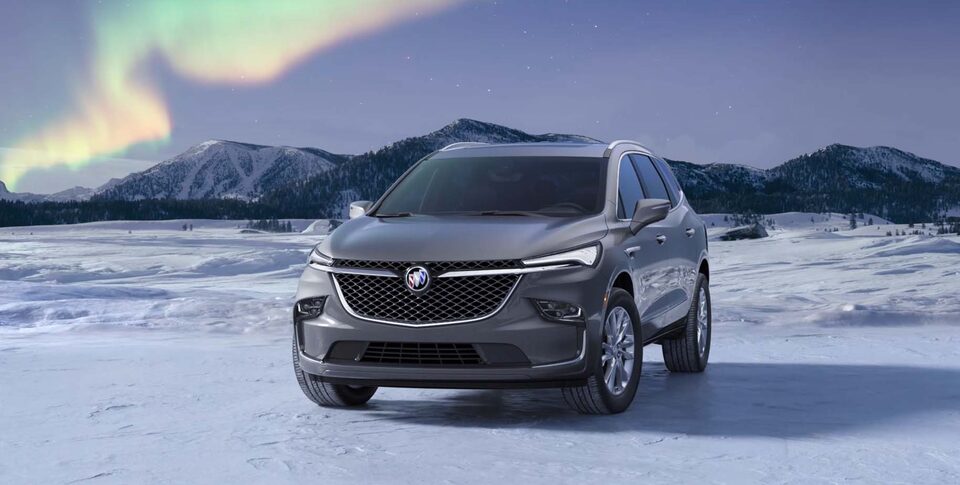 The Buick Enclave Parked In the Street next to a House