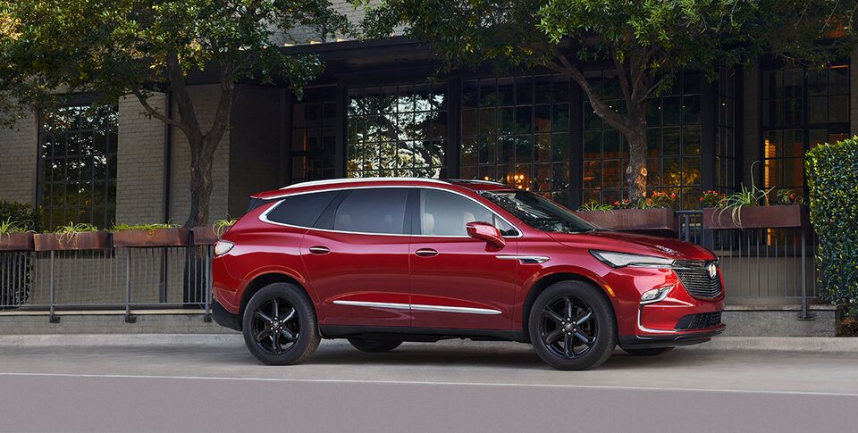 The Buick Enclave Parked In the Street next to a House