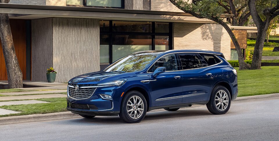 The Buick Enclave Parked In the Street next to a House