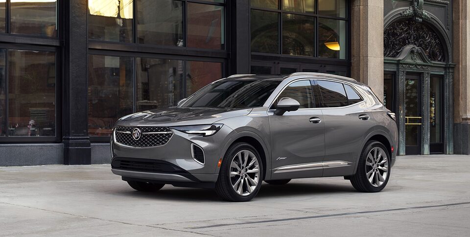The Buick Envision ST Parked On-Road on a Driveway Near a House