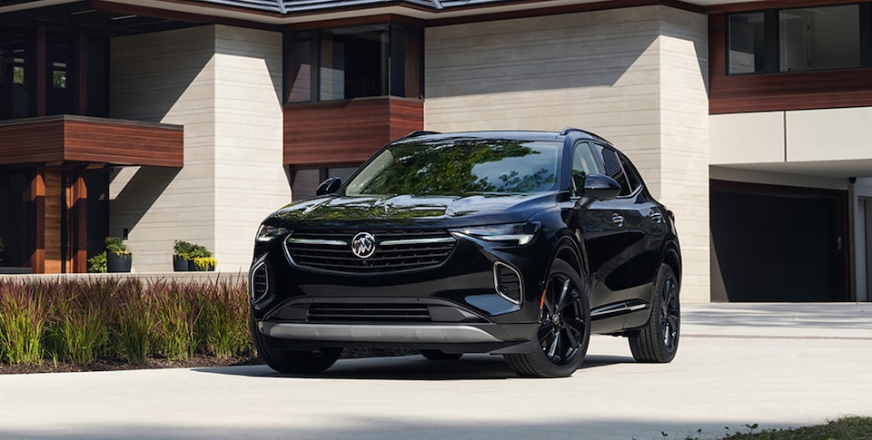 The Buick Envision ST Parked On-Road on a Driveway Near a House
