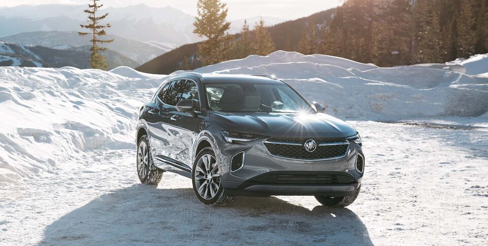 The Buick Envision ST Parked On-Road on a Driveway Near a House