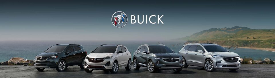 The Buick Logo over a Lineup of Buick Vehicles Parked on Snow