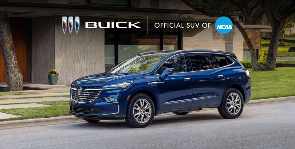 The Buick Enclave Parked In the Street next to a House
