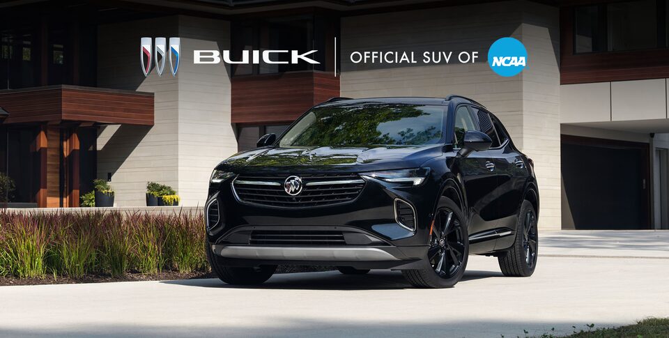 The Buick Envision ST Parked On-Road on a Driveway Near a House
