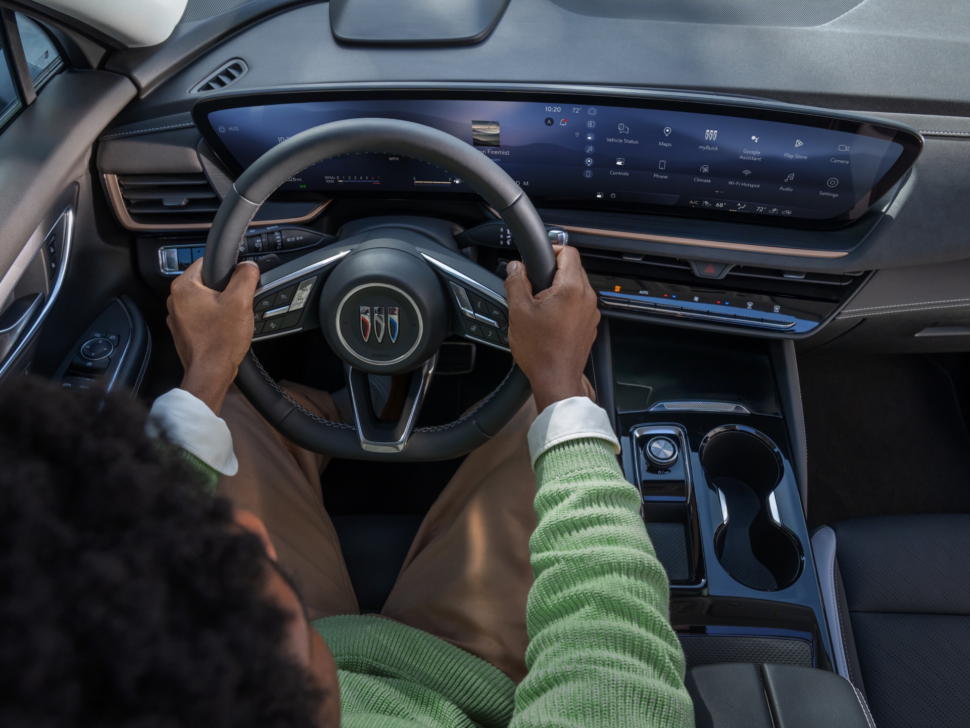 A Driver With Hands On the Steering Wheel of a Buick Vehicle With a Modern Digital Display