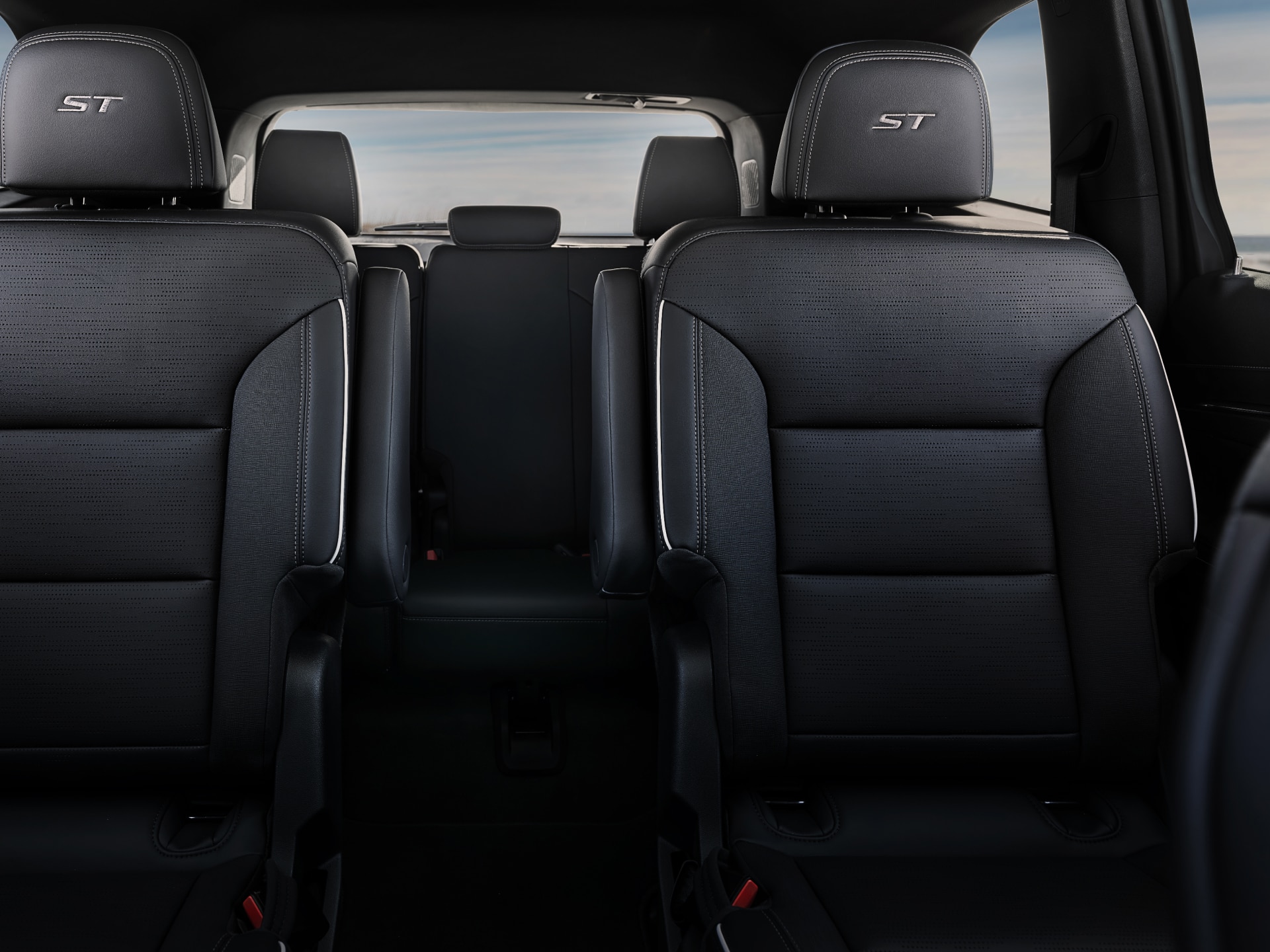 A Buick Enclave Interior with Three Rows of Black Leather Seats and a View of the Ocean