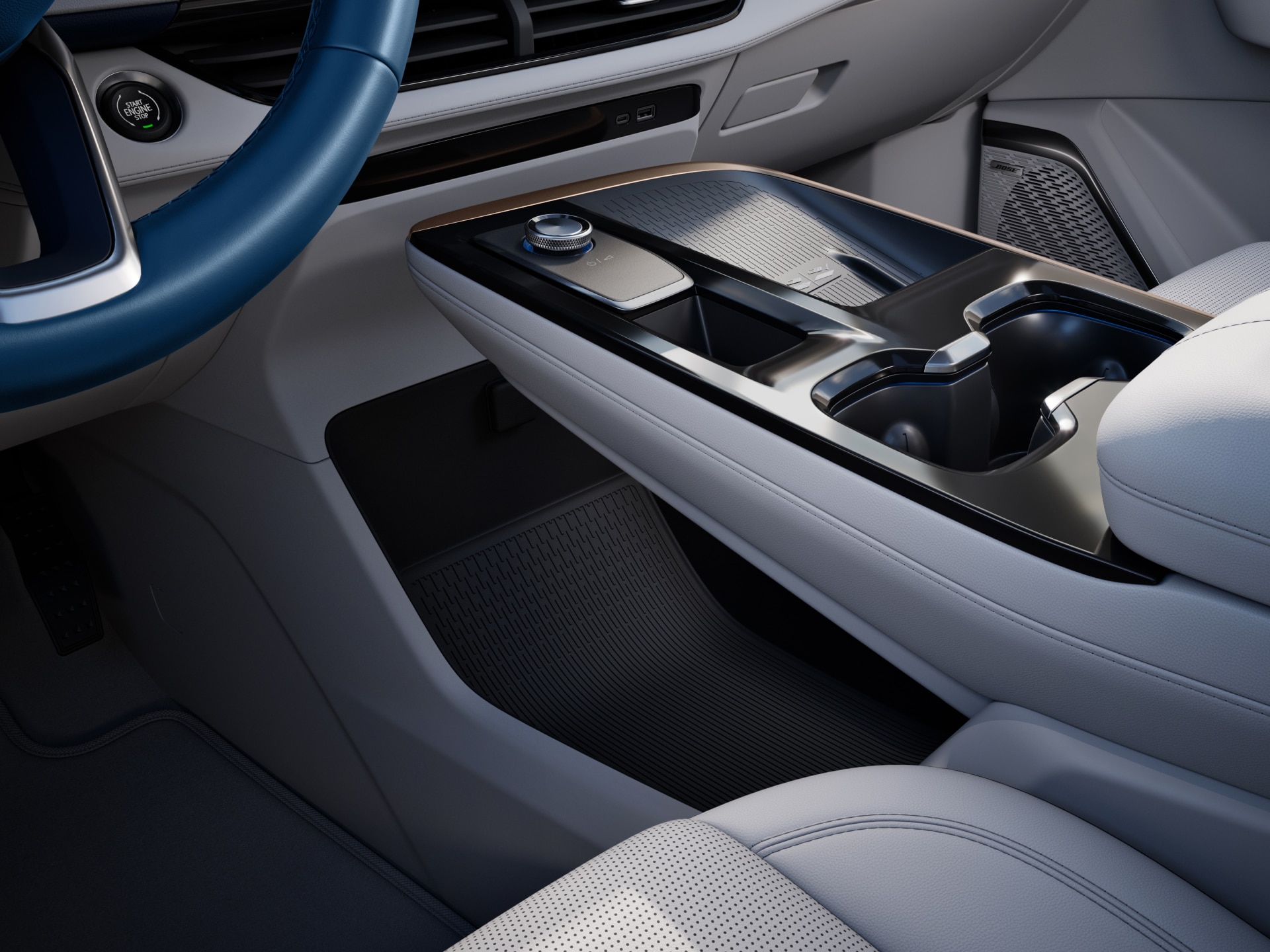 A Close-up of a Car's Center Console and Dashboard Area with a Gear Selector Dial and Cup Holders
