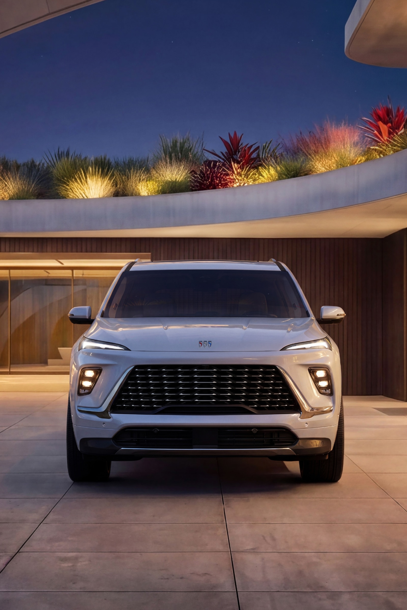 A Front View of a White Buick Enclave SUV at Dusk Showcasing Its Signature LED Lighting