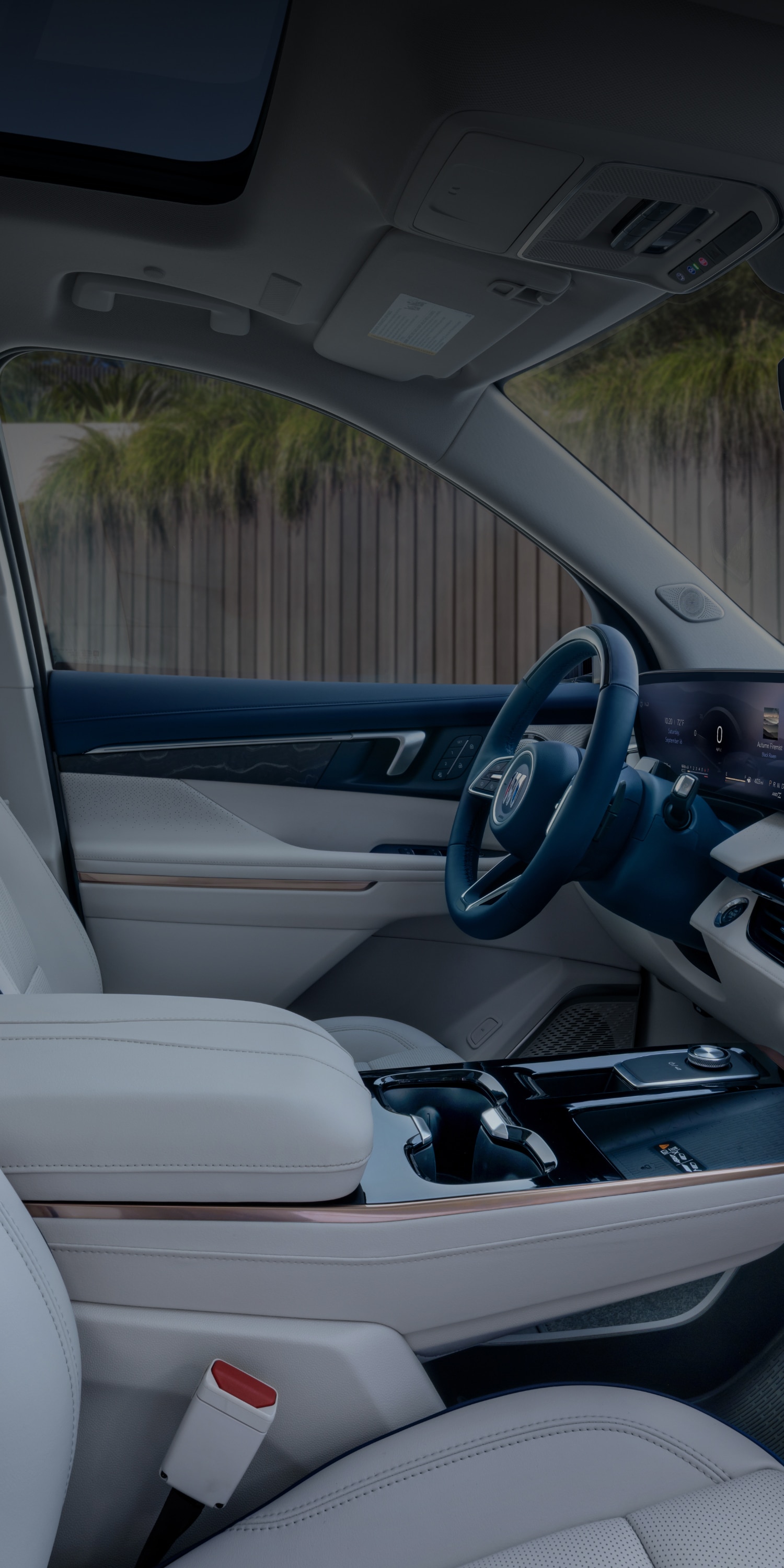 An Interior View of the White Rear Seats in a Buick Enclave with a Panoramic Sunroof