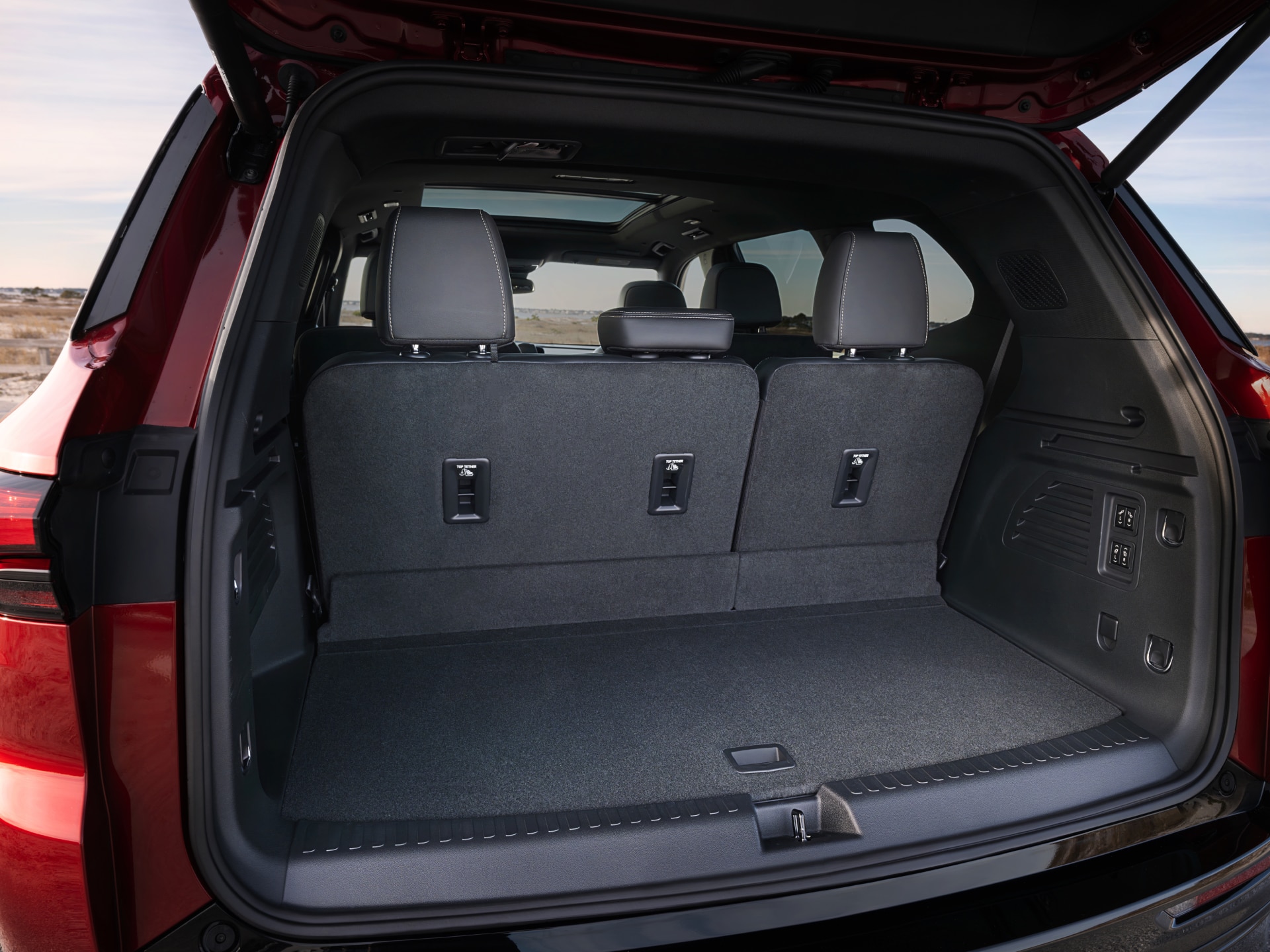 The Open Trunk of a Red Buick Enclave SUV with Gray Seats
