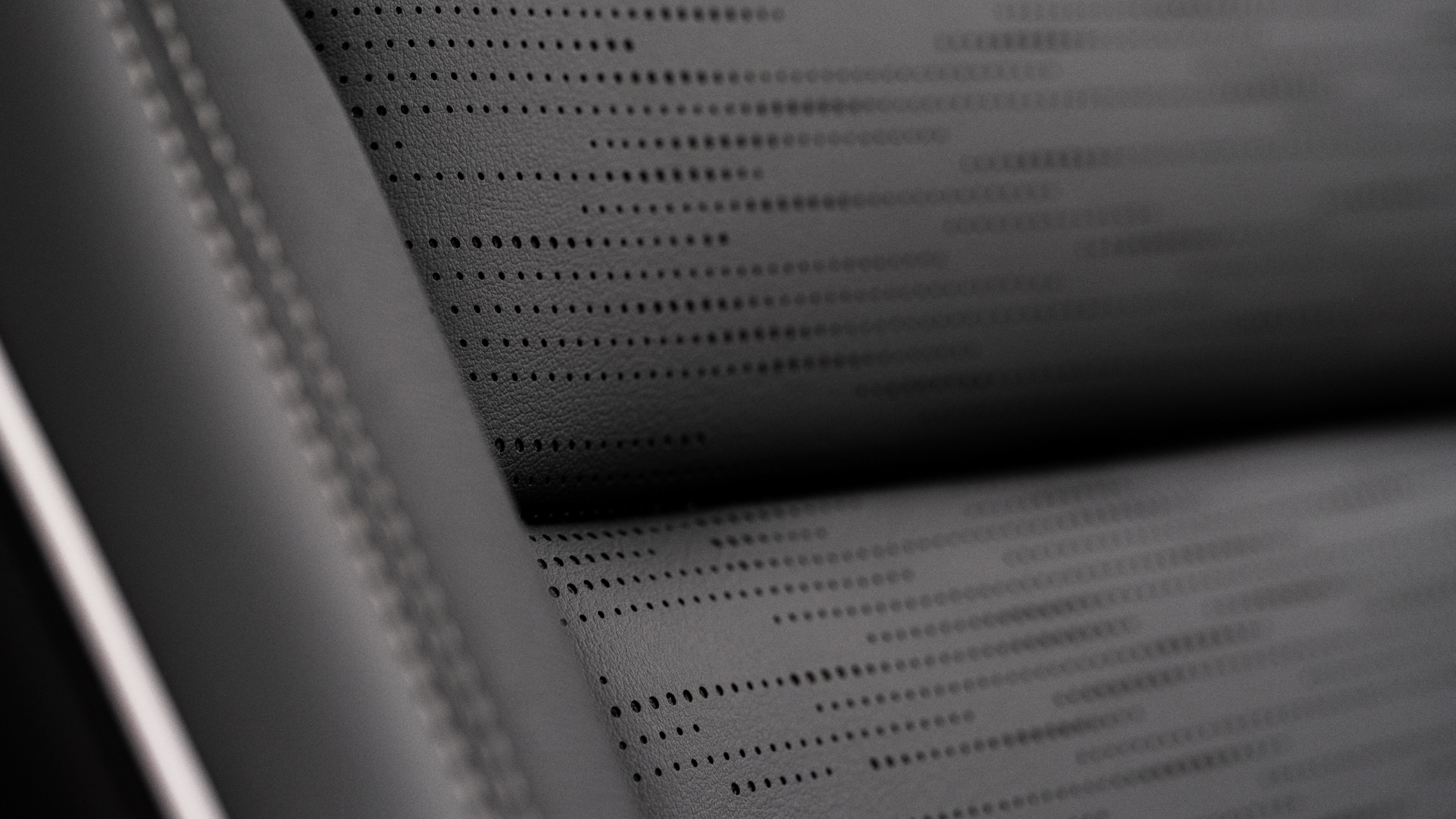 A Close-Up of a Perforated Dark Gray Buick Car Seat with Stitching Details