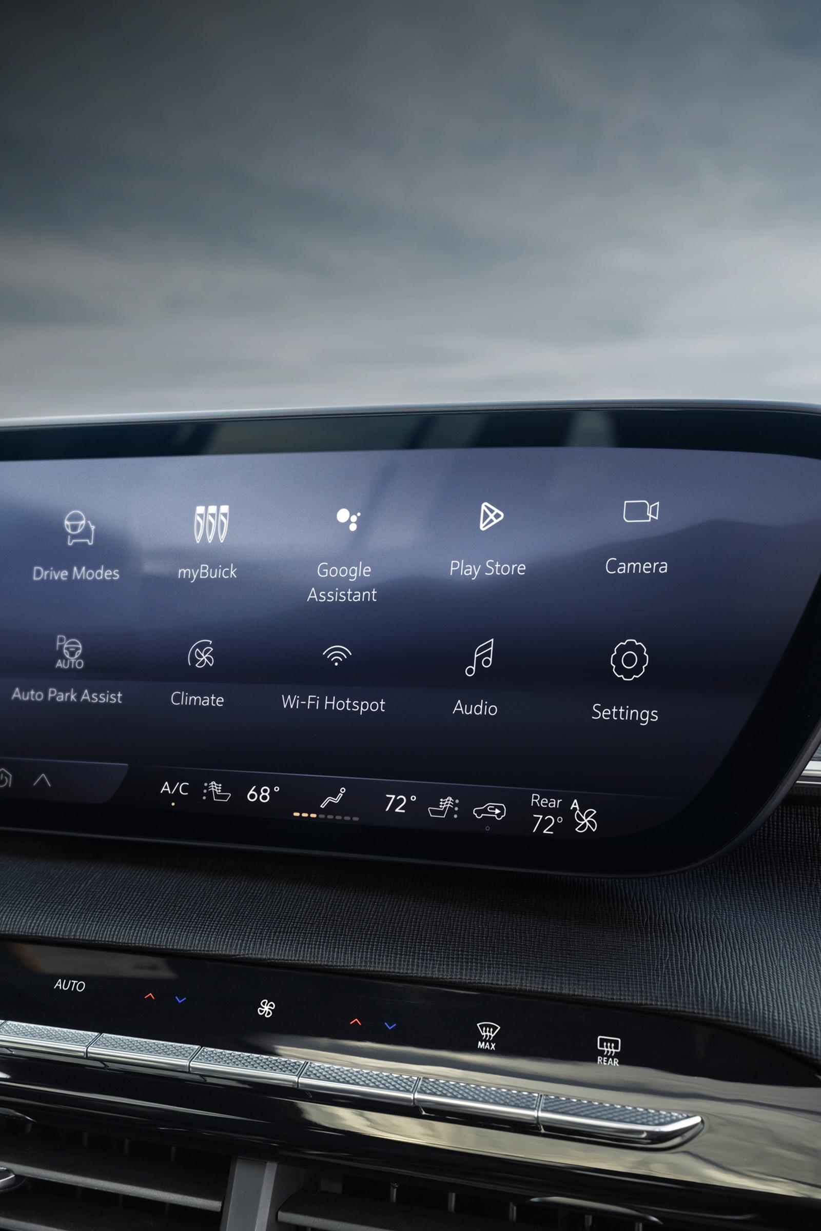 The Interior Dashboard of a Buick Car Featuring a Large Curved Infotainment Screen with App Icons