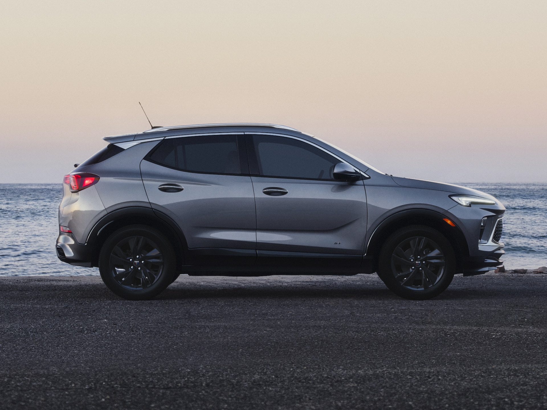 A Gray Buick Encore GX Parked by the Ocean at Sunset