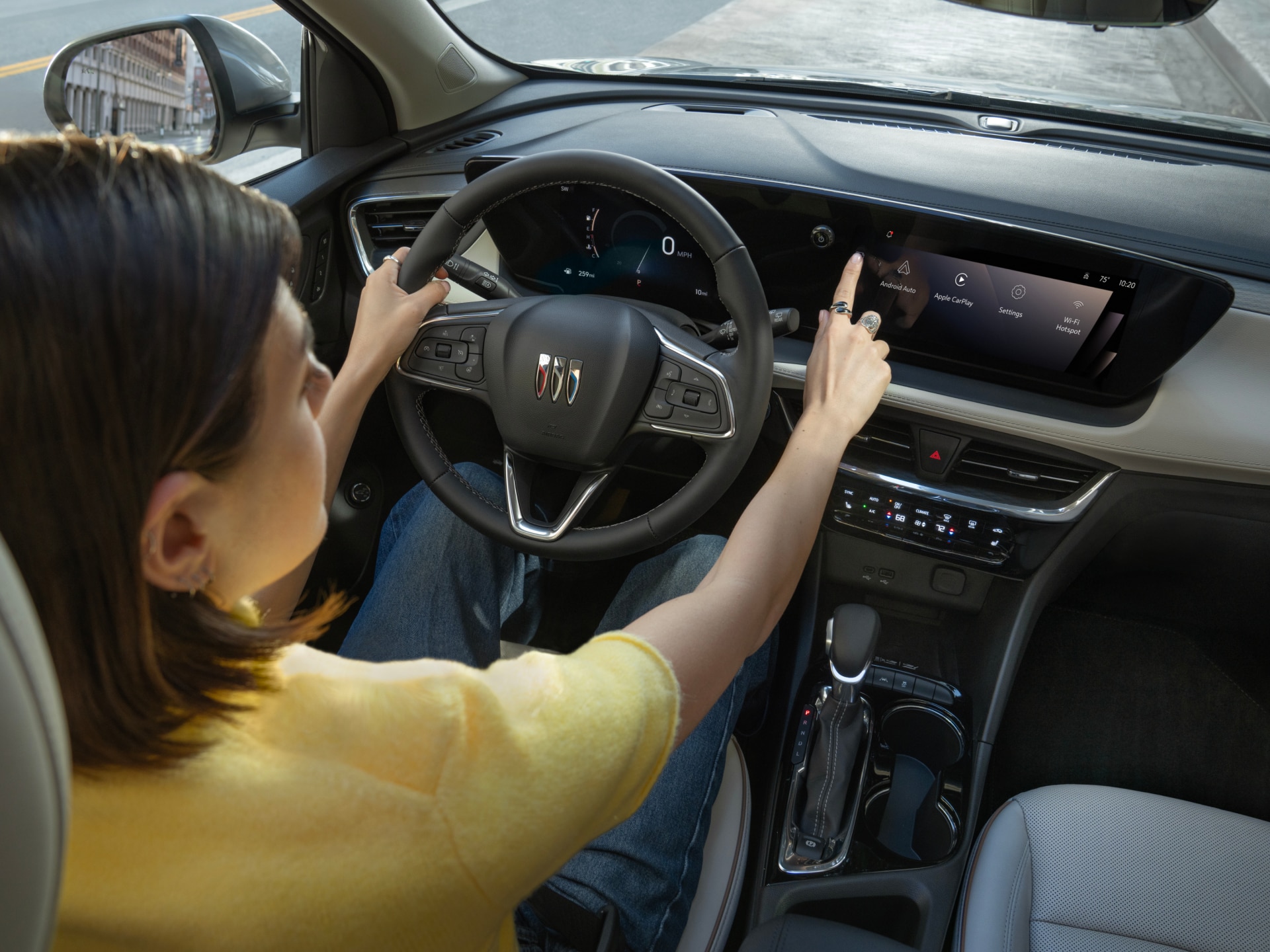 A Woman Driving a Buick Vehicle, Touching the Infotainment Screen on the Dashboard