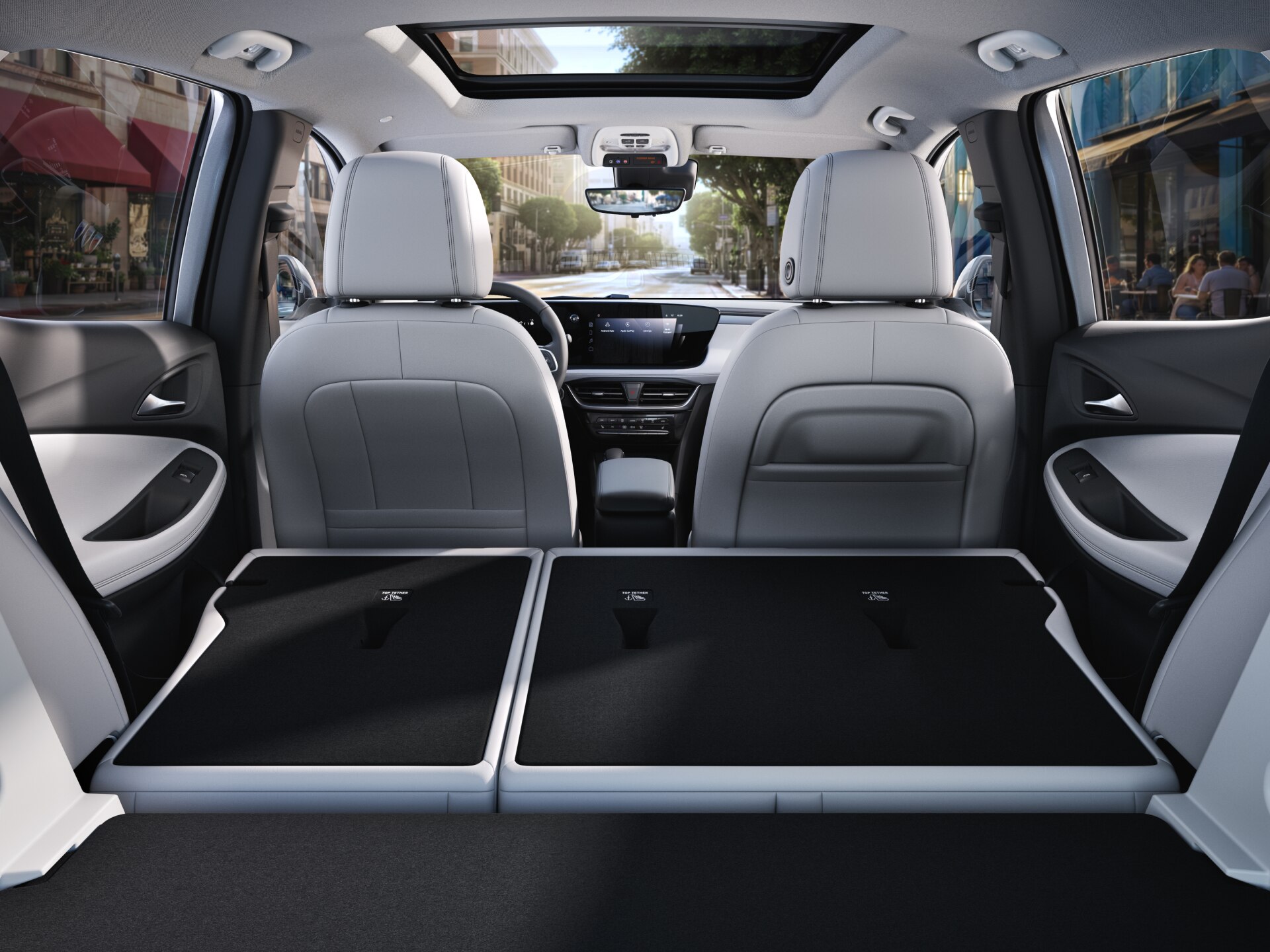 View From the Rear of a Buick SUV Interior with Folded-Flat Back Seats Showing Extended Cargo Space, Parked on a City Street