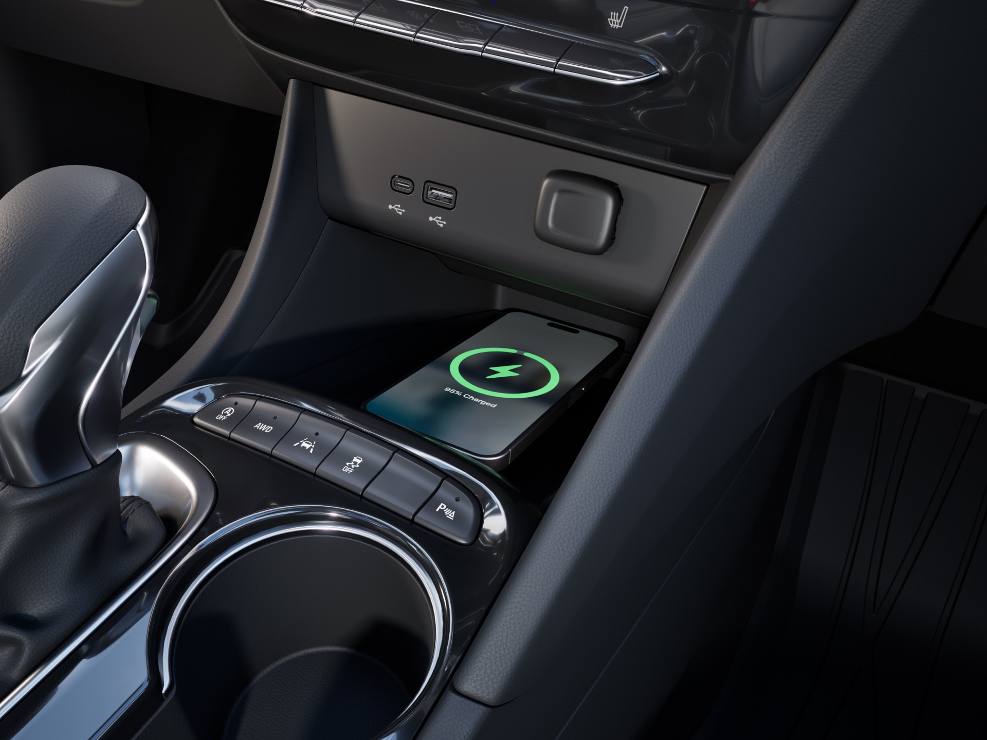 Center Console of a Buick Vehicle with a Smartphone Wirelessly Charging and Various Control Buttons
