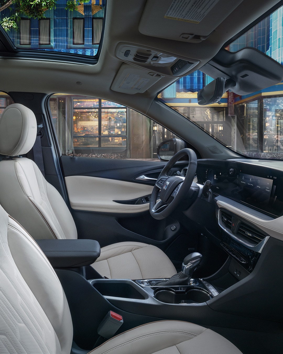 The Interior of a Buick Car Showing the Light-Colored Passenger Seats and Center Armrest