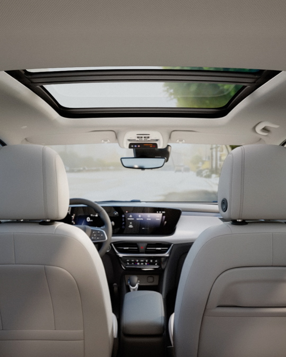 Interior View of a Buick Vehicle From the Back Seats Looking Forward Through the Open Sunroof with Gray Headrests