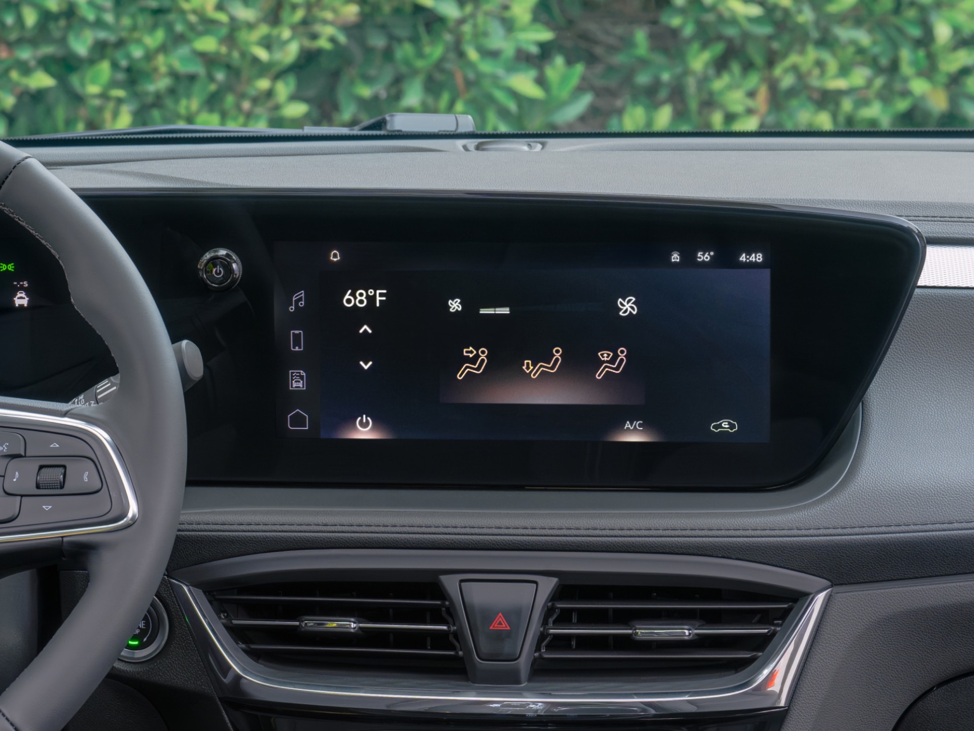 The Interior Dashboard of a Buick Showing the Steering Wheel, Digital Cluster, and Infotainment Screen