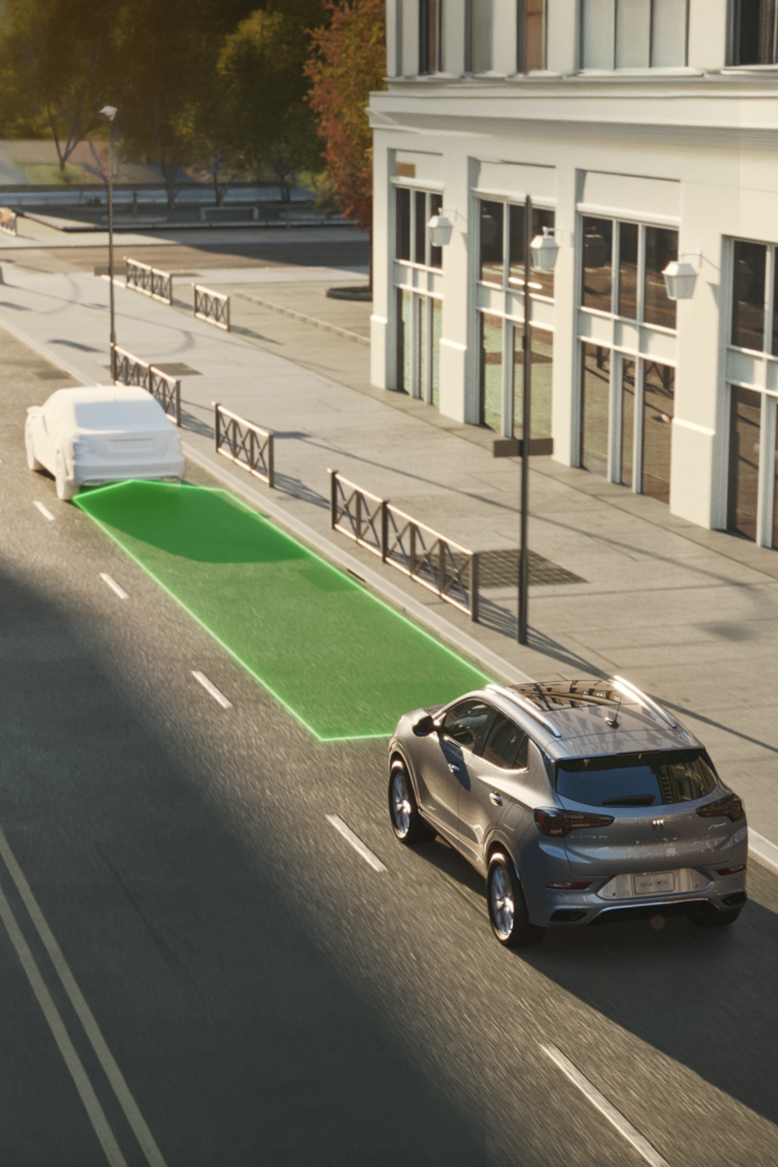 An Overhead View of a Gray Buick Encore Gx Suv Driving on a City Street, with a Green Safe Distance Area Highlighted Ahead of the Car