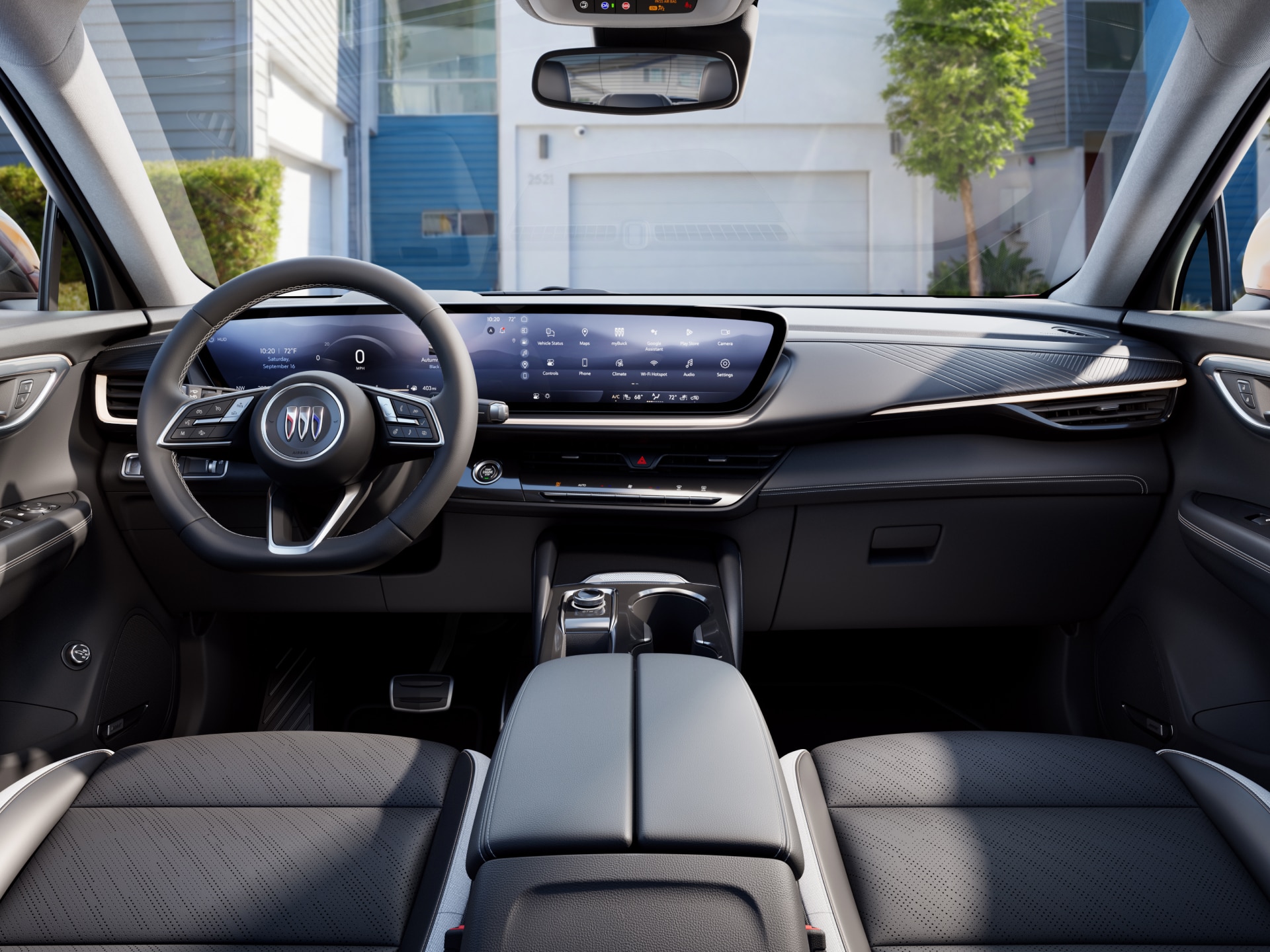 The Interior Dashboard of a Buick with a Steering Wheel and Wide Digital Displays