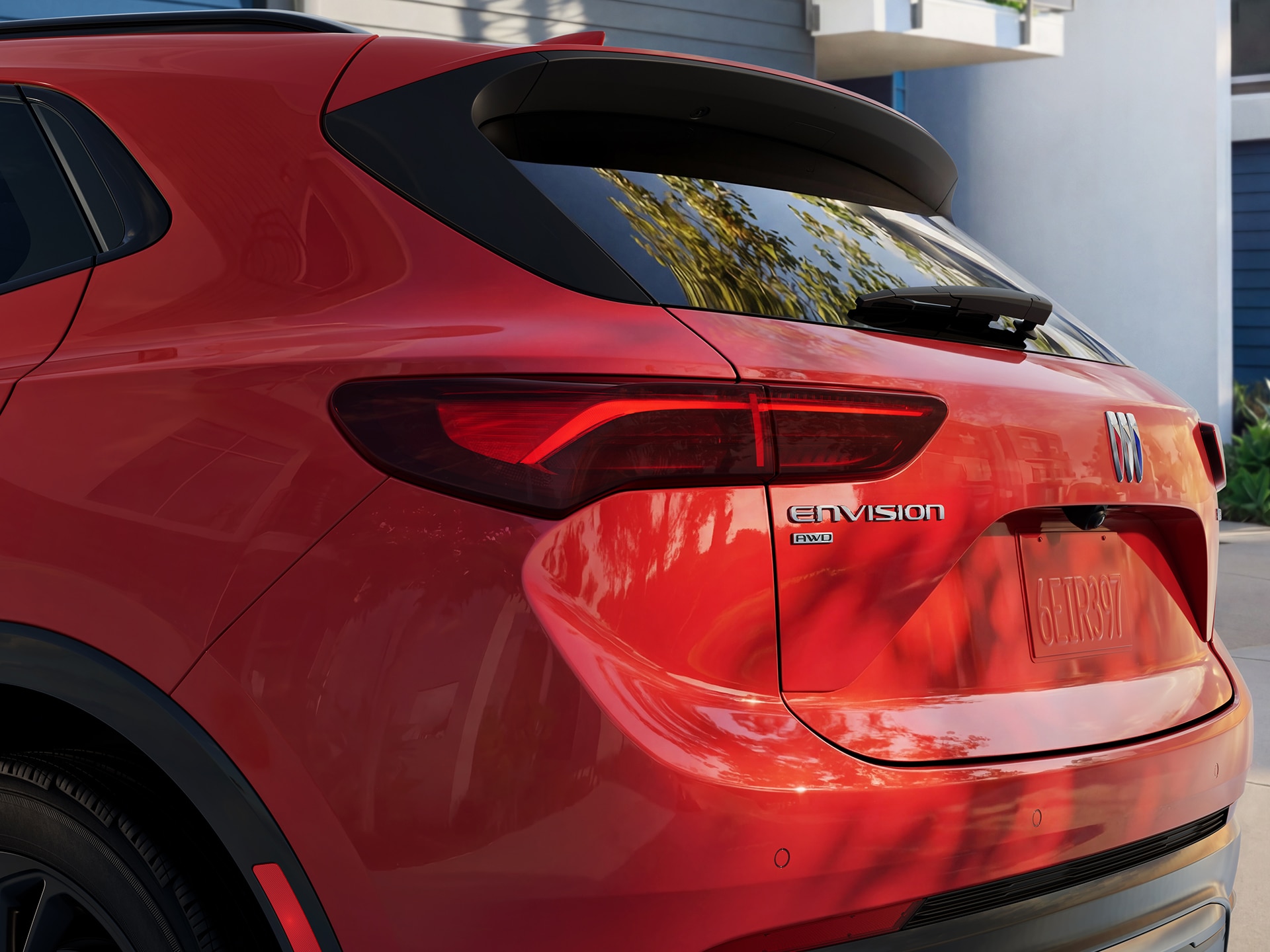 The Rear Driver Side Tail Light and Envision Badge ON a Red 2027 Buick Envision