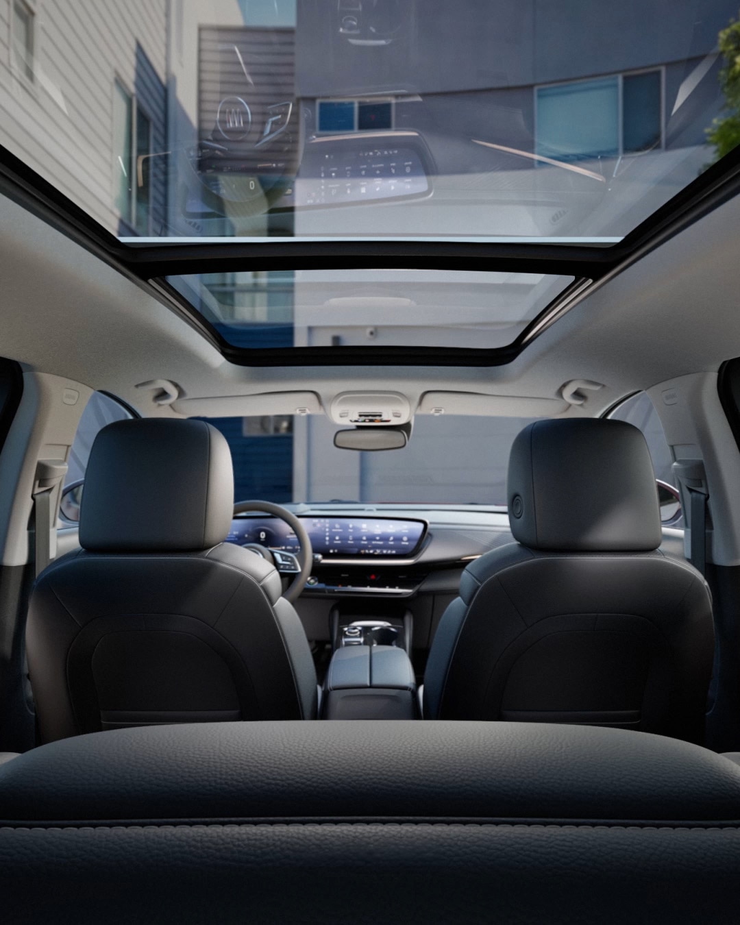 Interior View Looking Forward from the Rear Seats of the 2027 Buick Envision, Showing the Panoramic Sunroof and Dashboard