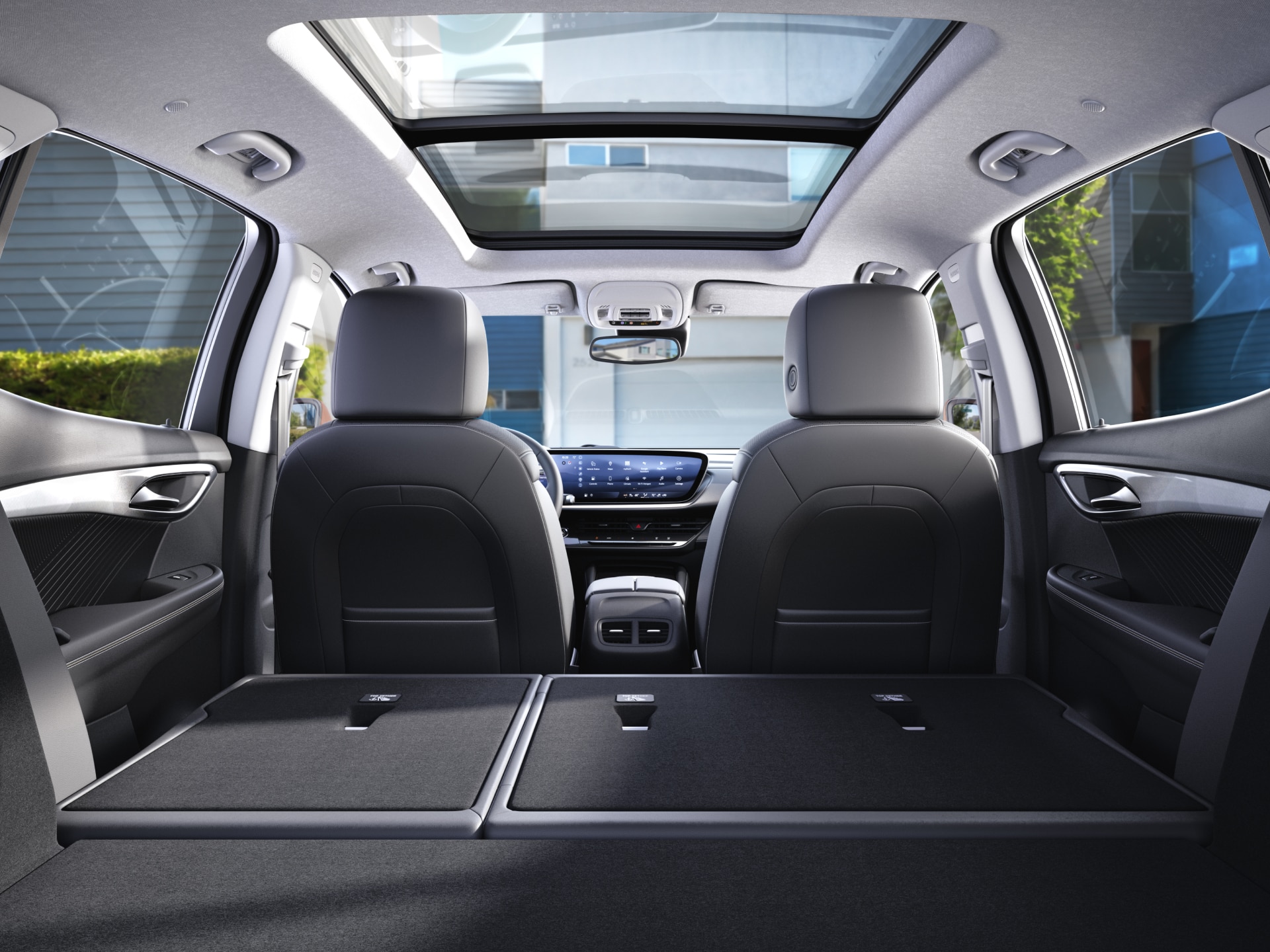Rear View Inside the 2027 Buick Envision Showing the Panoramic Sunroof and Rear Seats Folded Down for Cargo Space