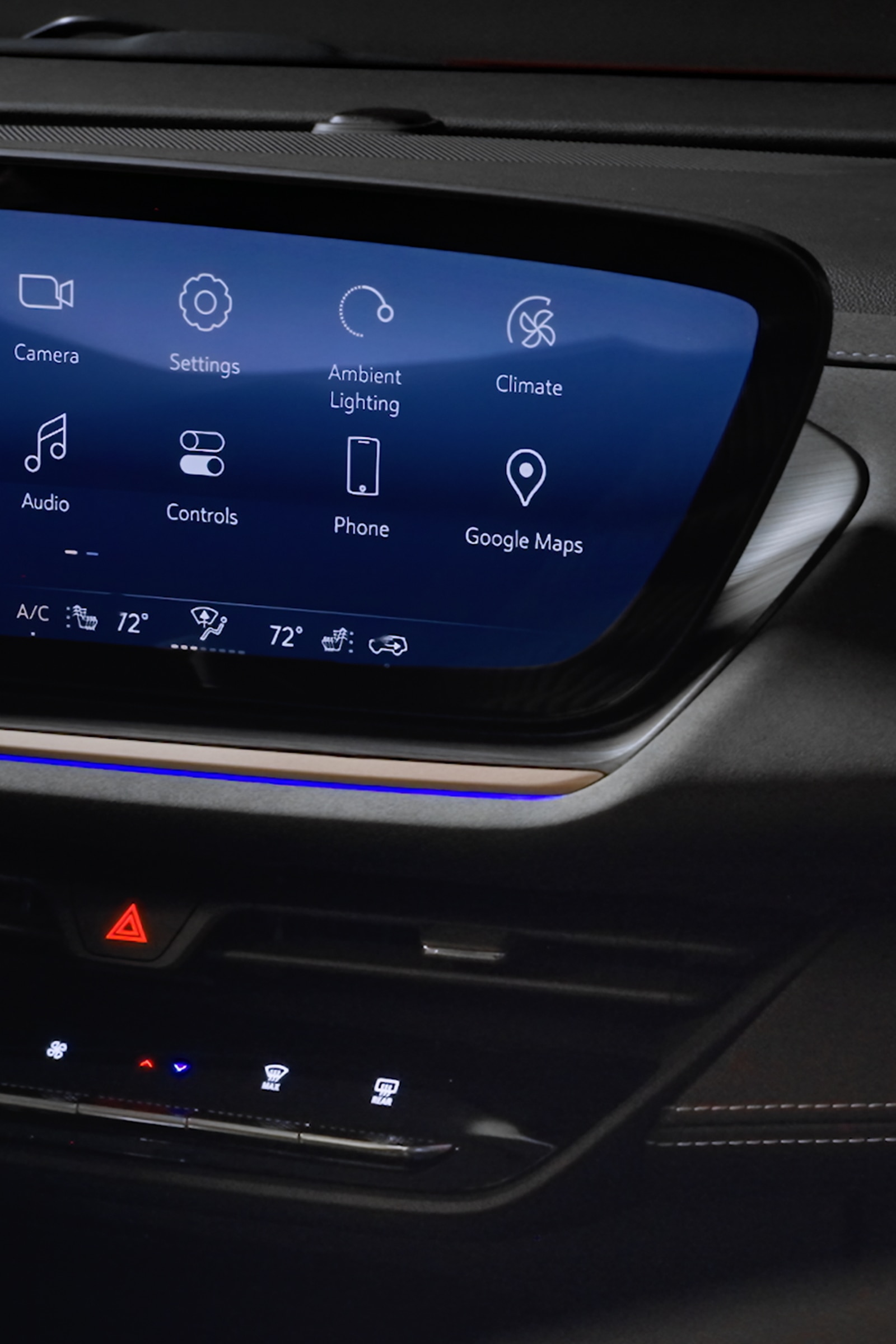 Dark Interior View of a Buick Vehicle's Dashboard with an Infotainment Screen and Blue Ambient Lighting