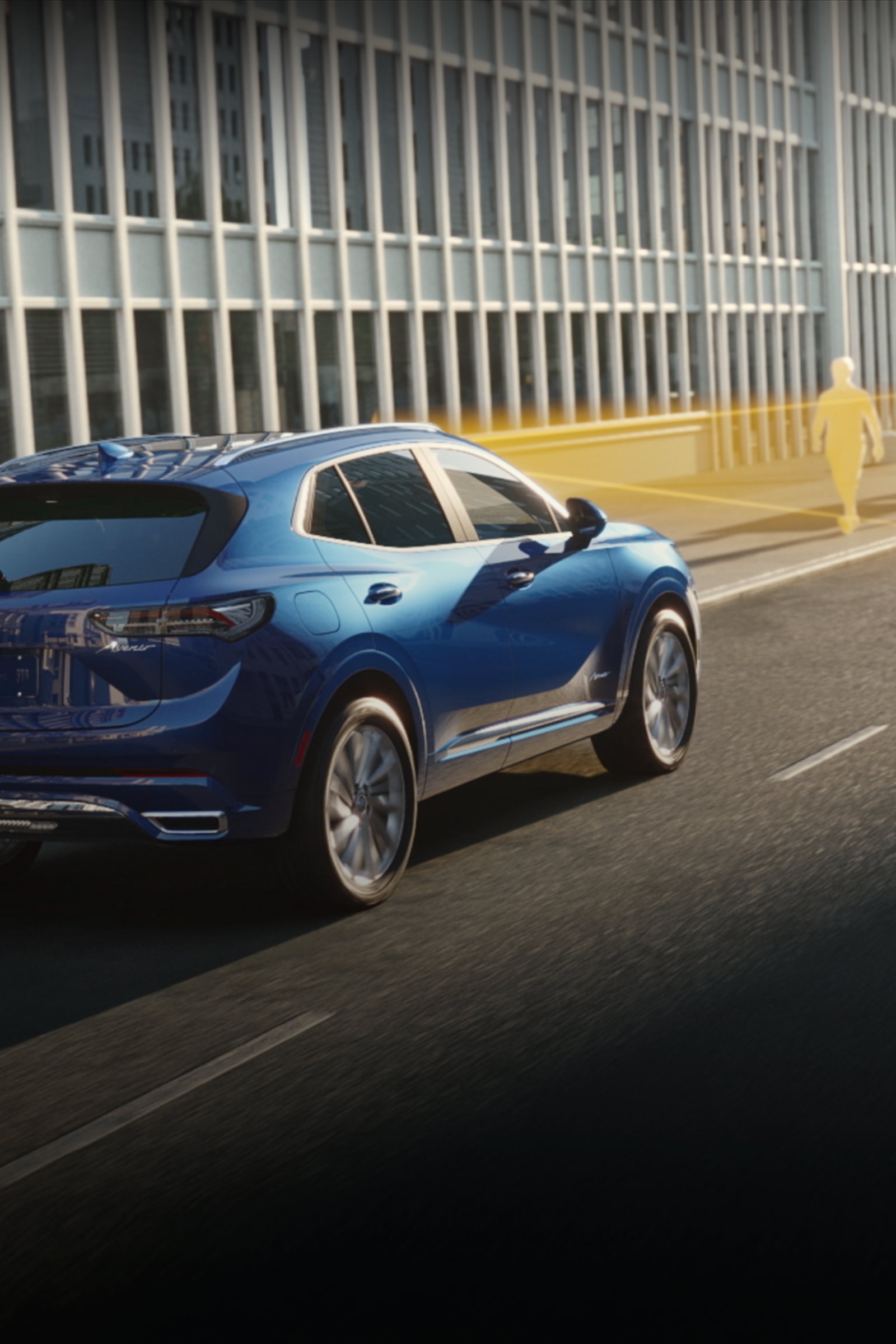 A Blue Buick Envista SUV Driving on a City Street with a Safety Feature Highlighting a Pedestrian