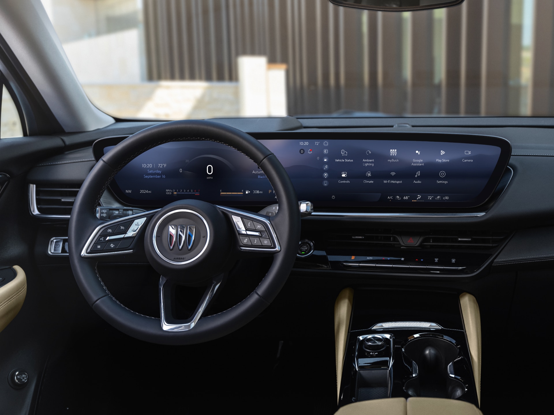 The Full Interior Front View of a Buick Car with a Steering Wheel a Panoramic Digital Display and Light-Colored Seats