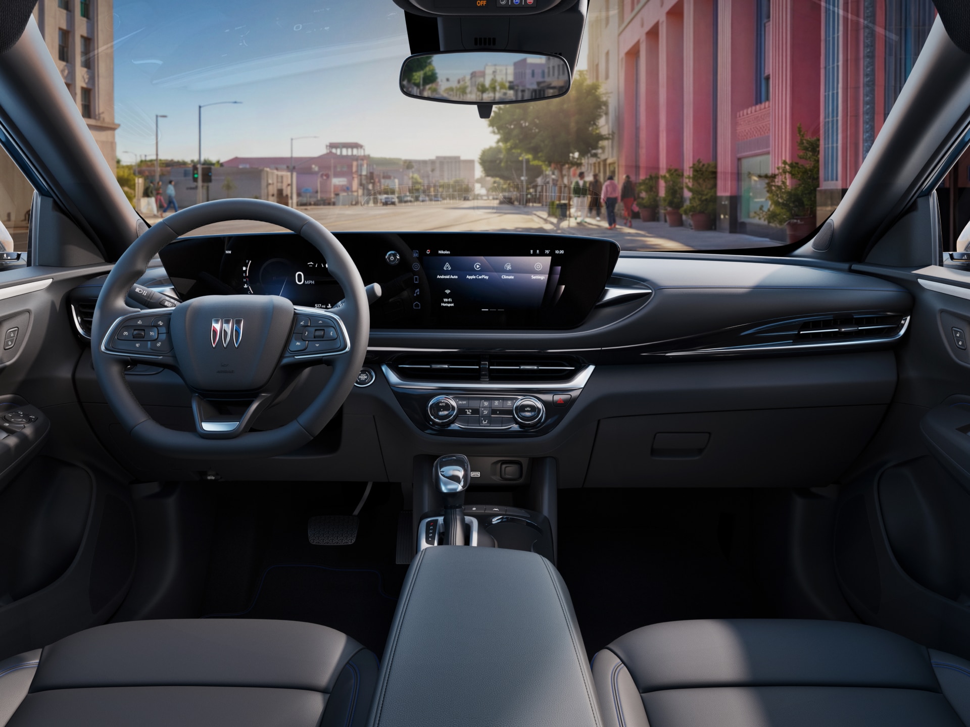 The Front Cabin of a Buick SUV Facing a Colorful City Street through the Windshield