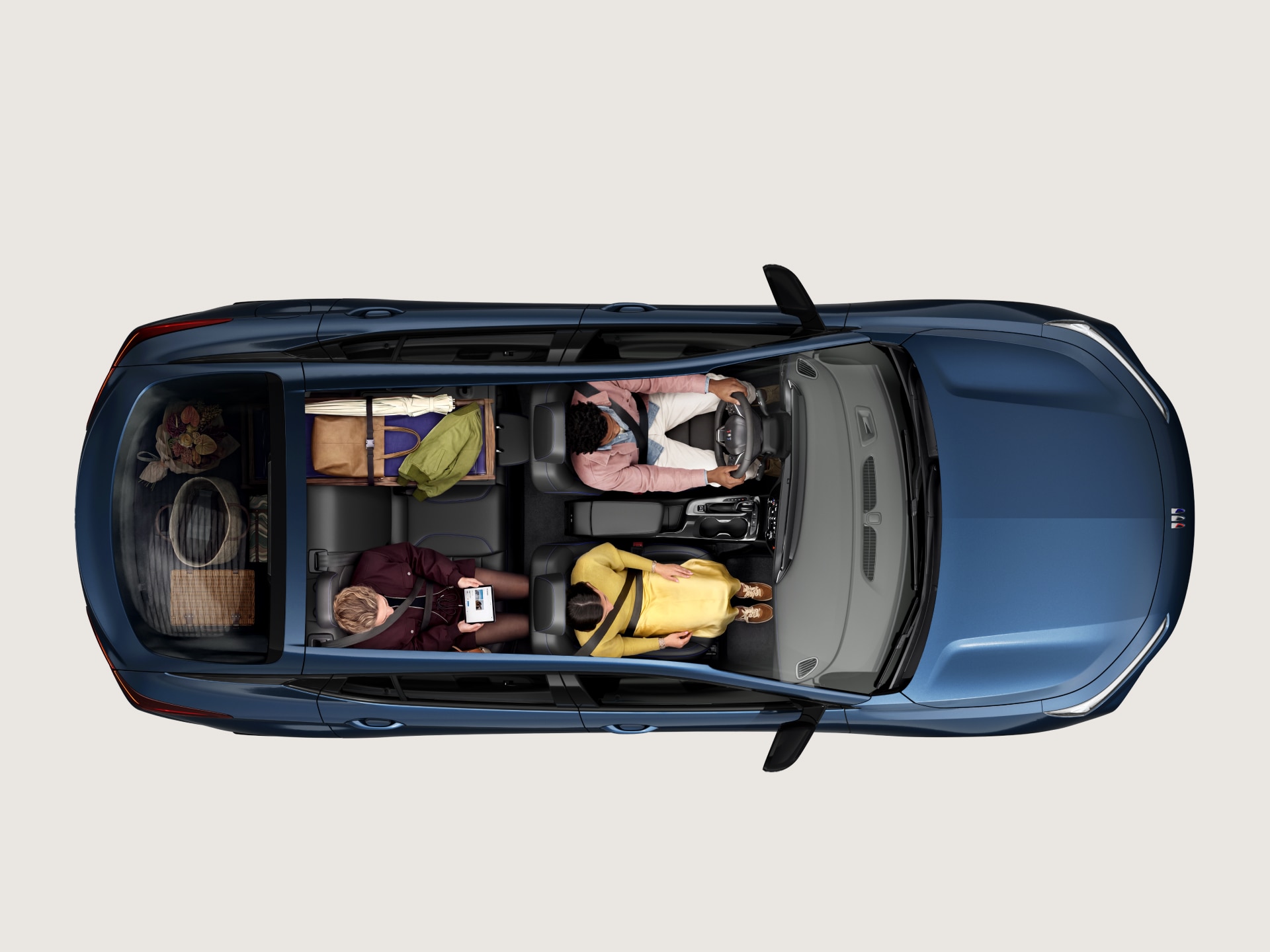Overhead View of a Blue Buick SUV Showing Passengers Seated in the Cabin with Luggage in the Rear Cargo Area