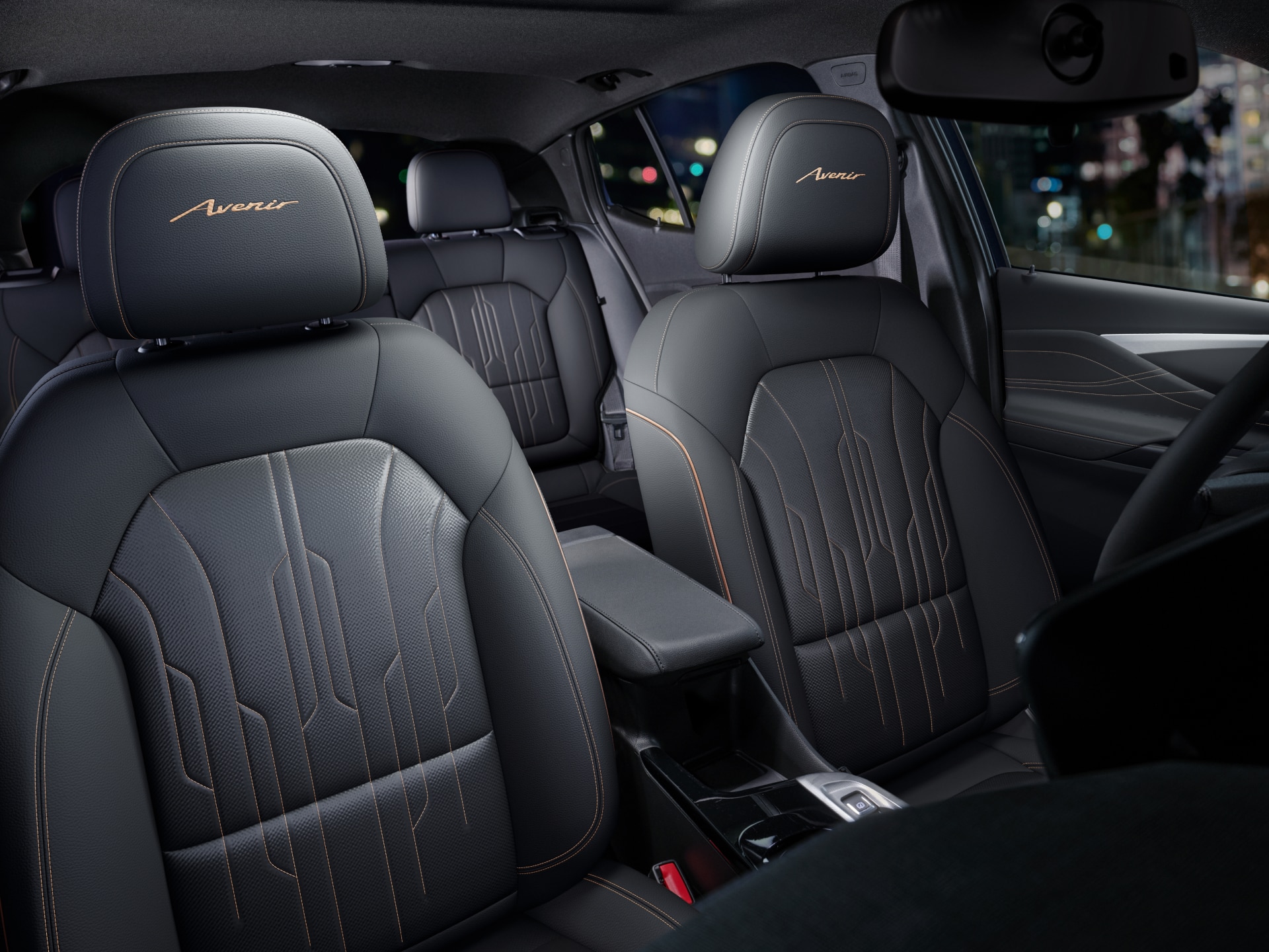 The Interior View of the Front and Rear Seats of a Buick Avenir with Dark Leather and Stitching