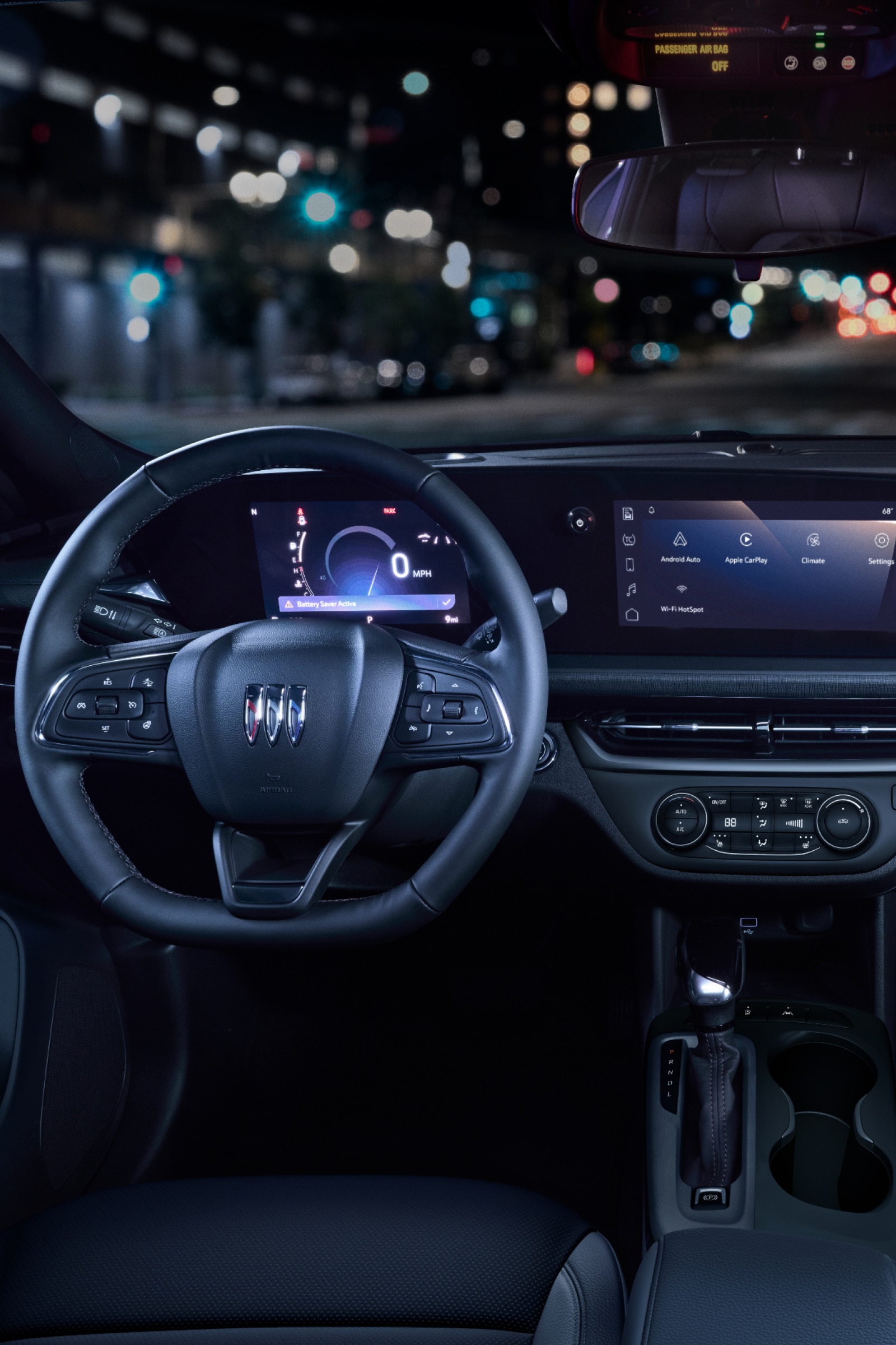 The Interior of a Buick at Night Showing the Steering Wheel and the Illuminated Screens