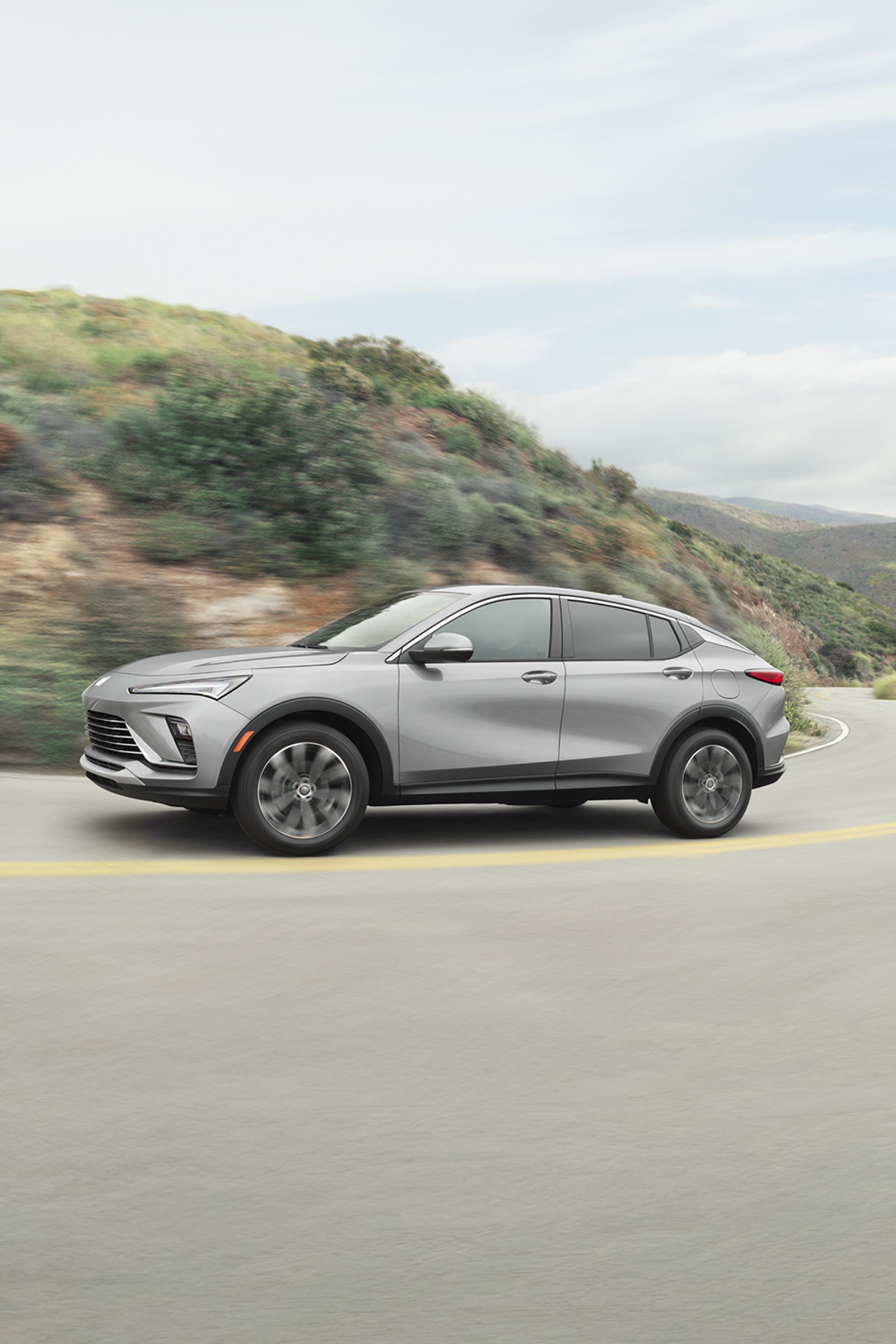 A Gray Buick Envista Driving on a Winding Road
