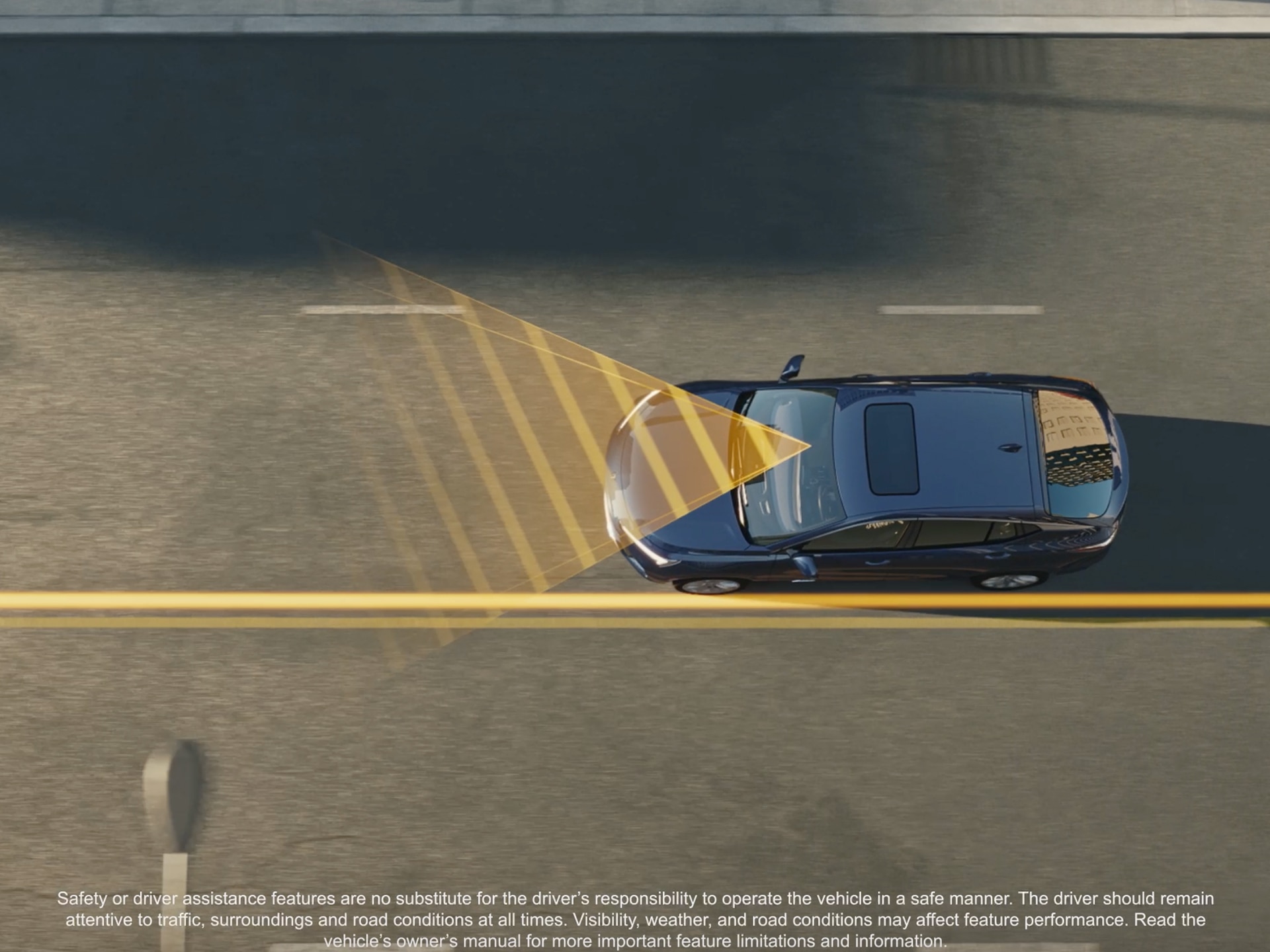 An Aerial View of a Gray Buick SUV Driving on a Road, with Yellow Lines on the Pavement Indicating Safety Features
