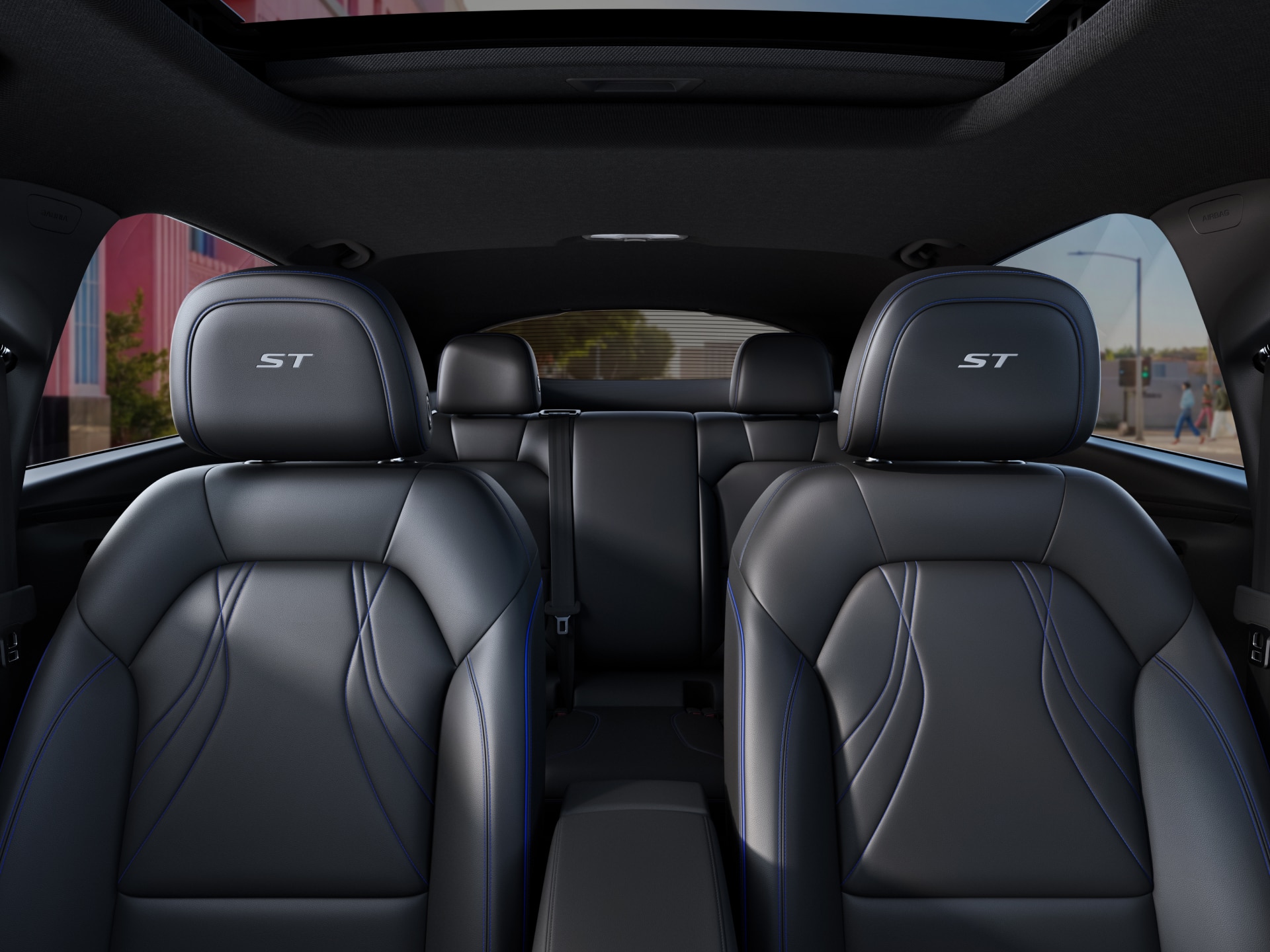 A Rear Interior View of a Buick Envision Showing Two Rows of Black Leather Seats with Blue Stitching and ST Embroidered Headrests