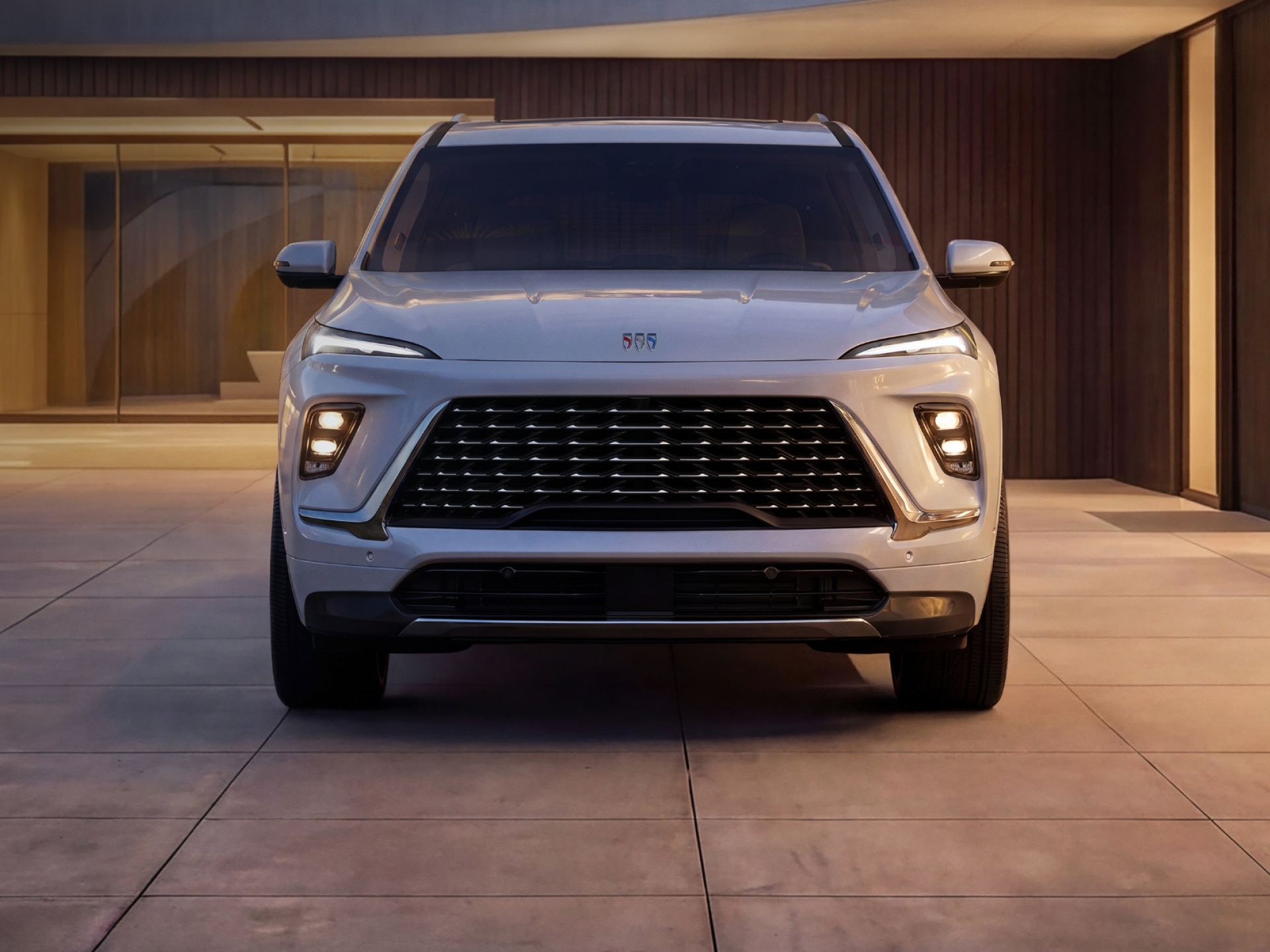 A Front View of a White Buick Enclave SUV in Daytime Showcasing Its Signature LED Lighting