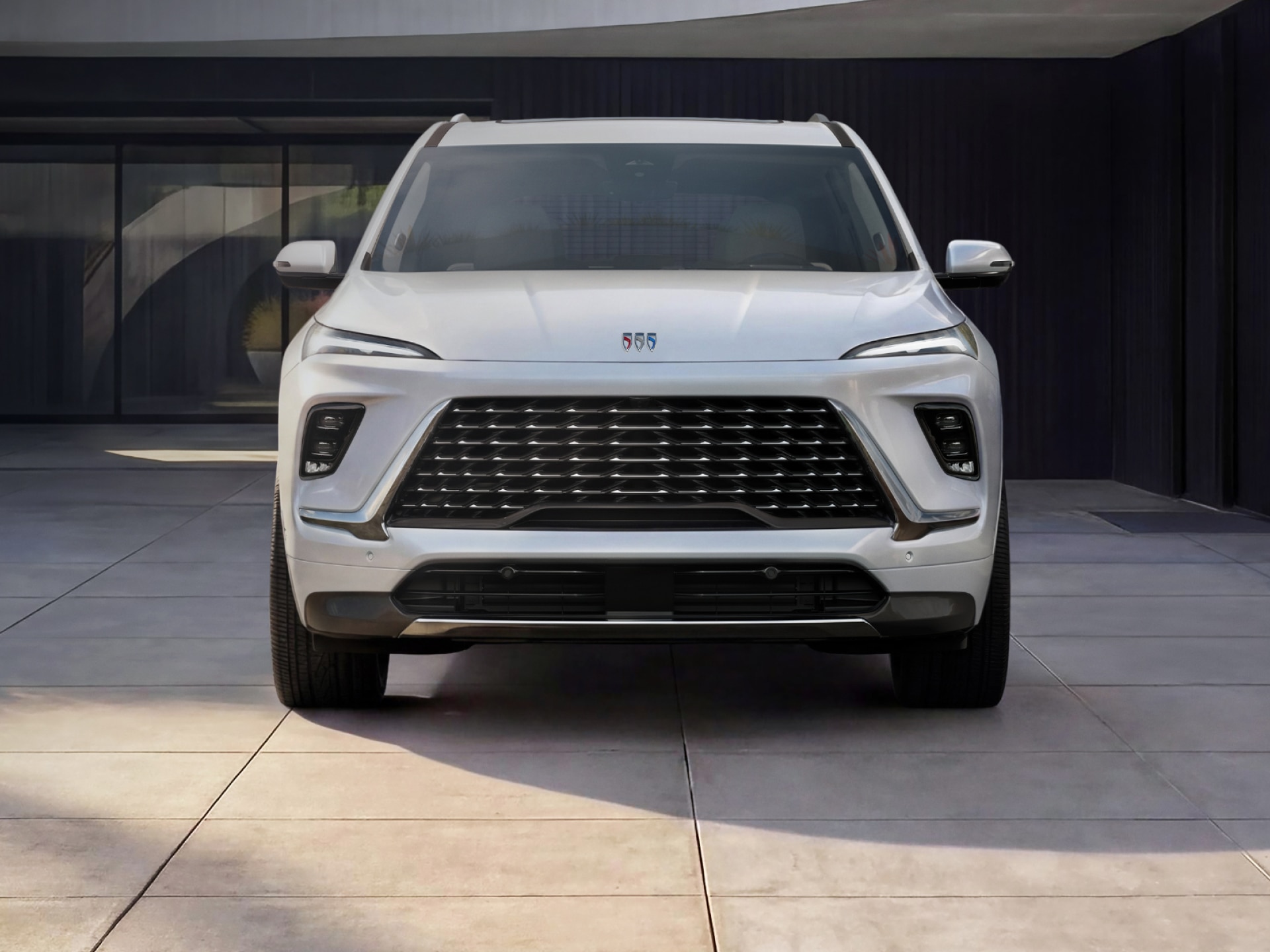 A Front View of a White Buick Enclave SUV at Dusk Showcasing Its Signature LED Lighting