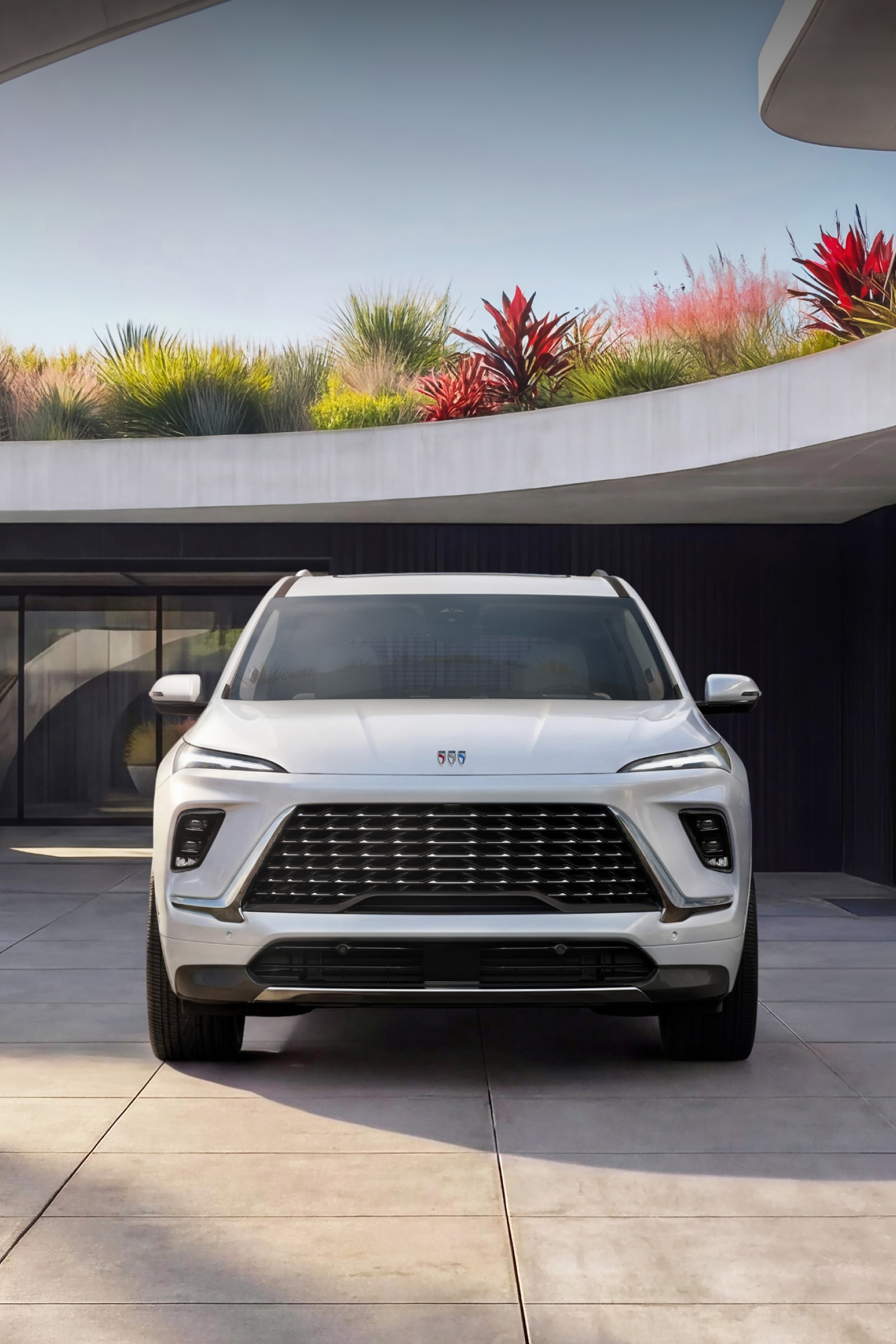 A Front View of a White Buick Enclave SUV at Dusk Showcasing Its Signature LED Lighting
